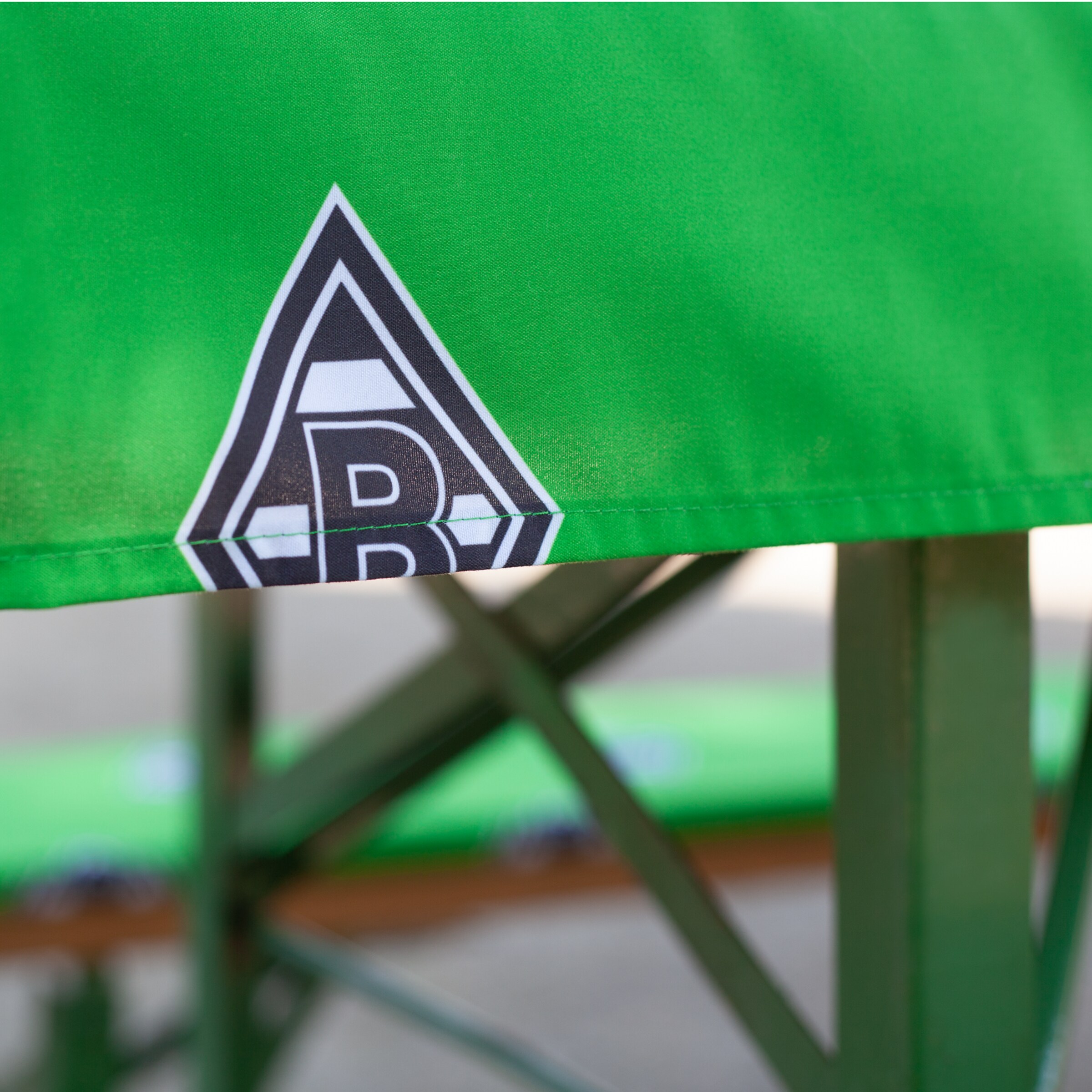 Seating with Borussia Mönchengladbach logo on green fabric.