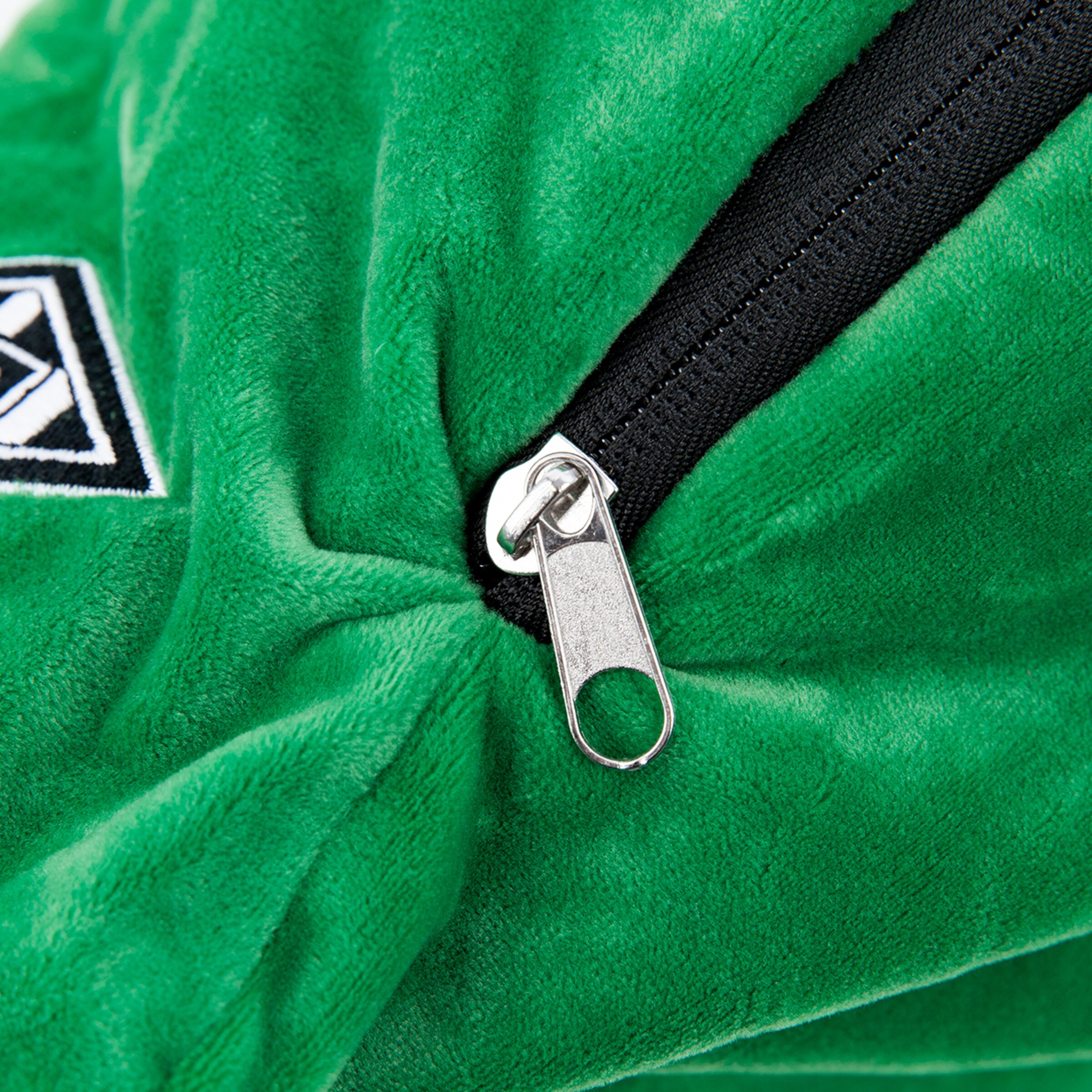 Close-up of a green fabric with a zipper.