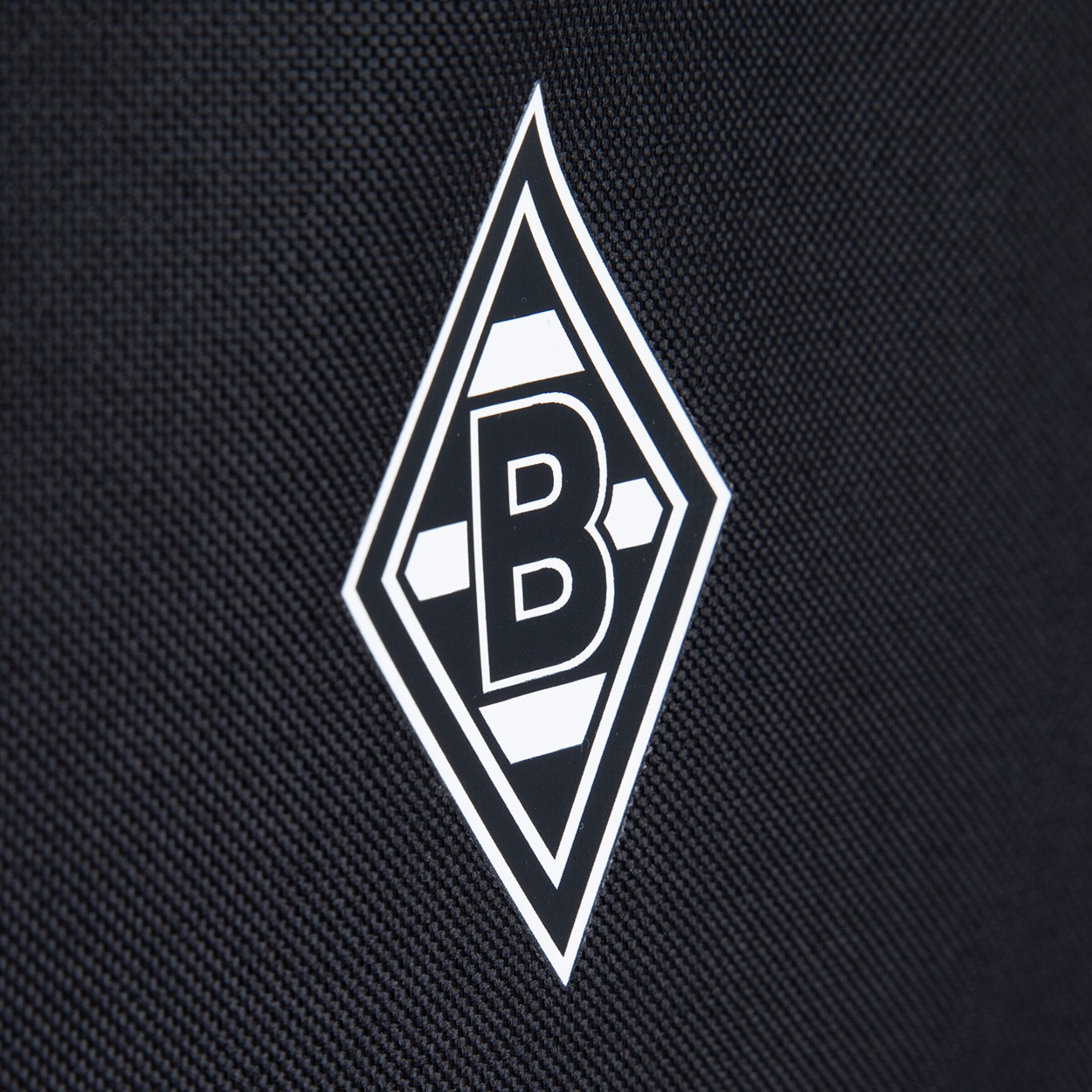 Logo von Borussia Mönchengladbach in schwarz-weißer Darstellung auf strukturierter Oberfläche