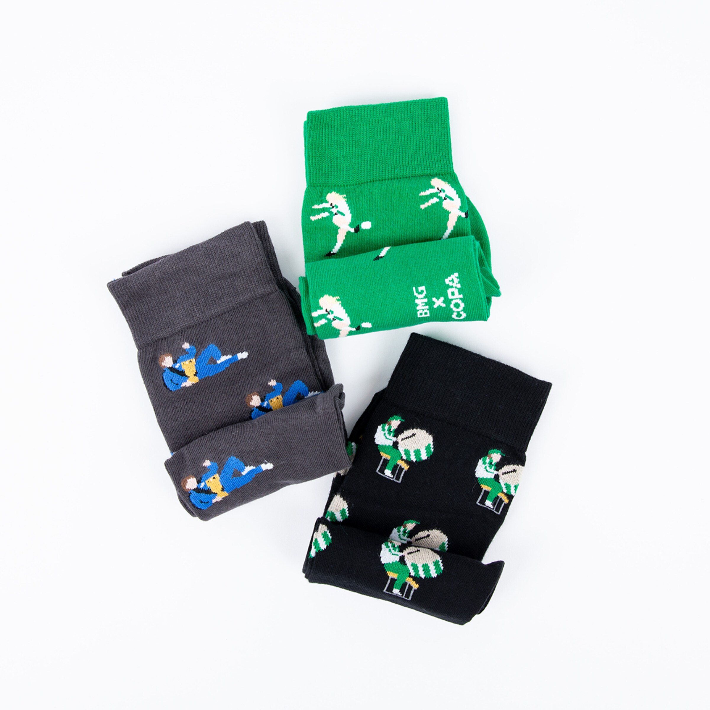 Three pairs of socks in different colors with soccer motifs.
