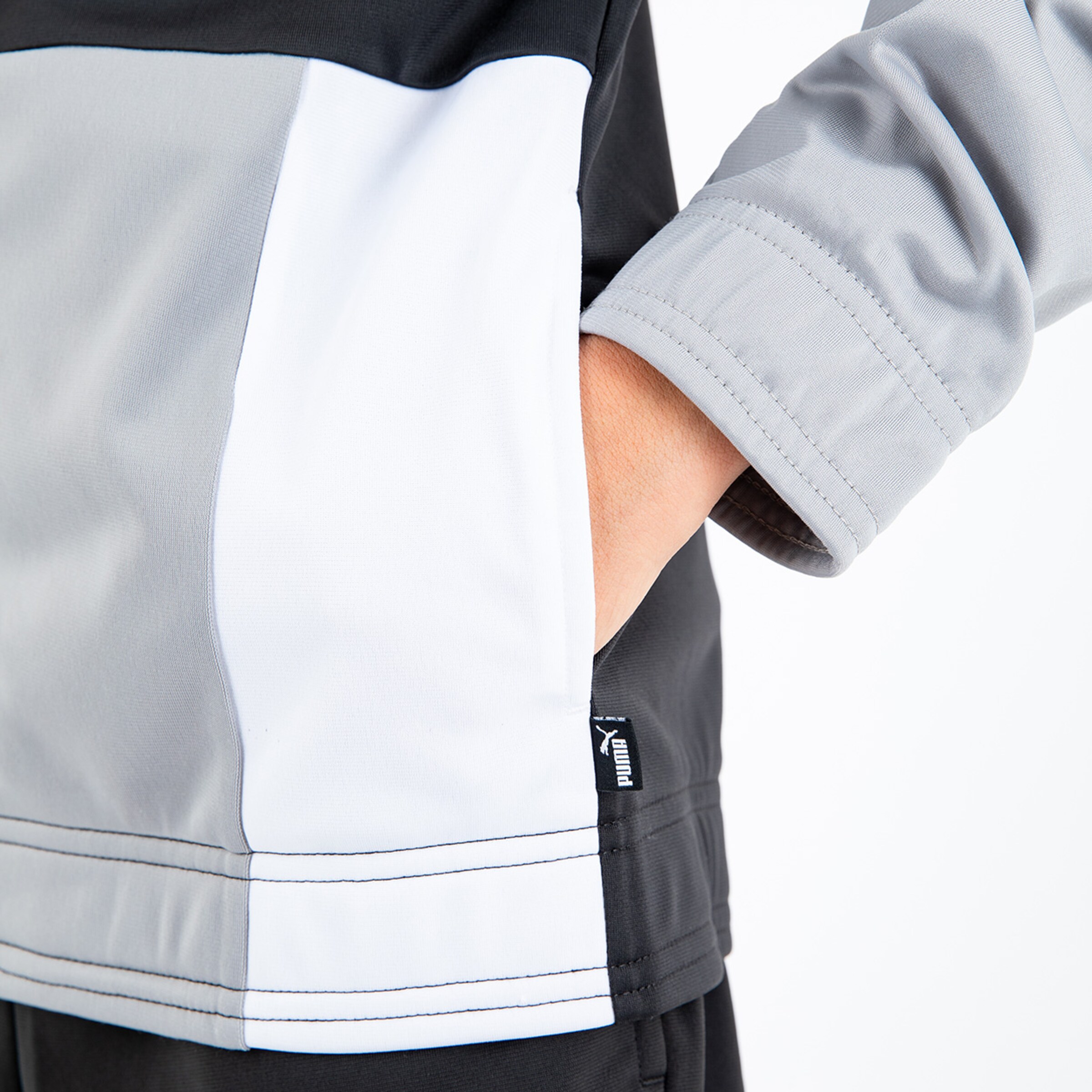 Gray jacket with seamless pocket and Puma logo on the sleeve.