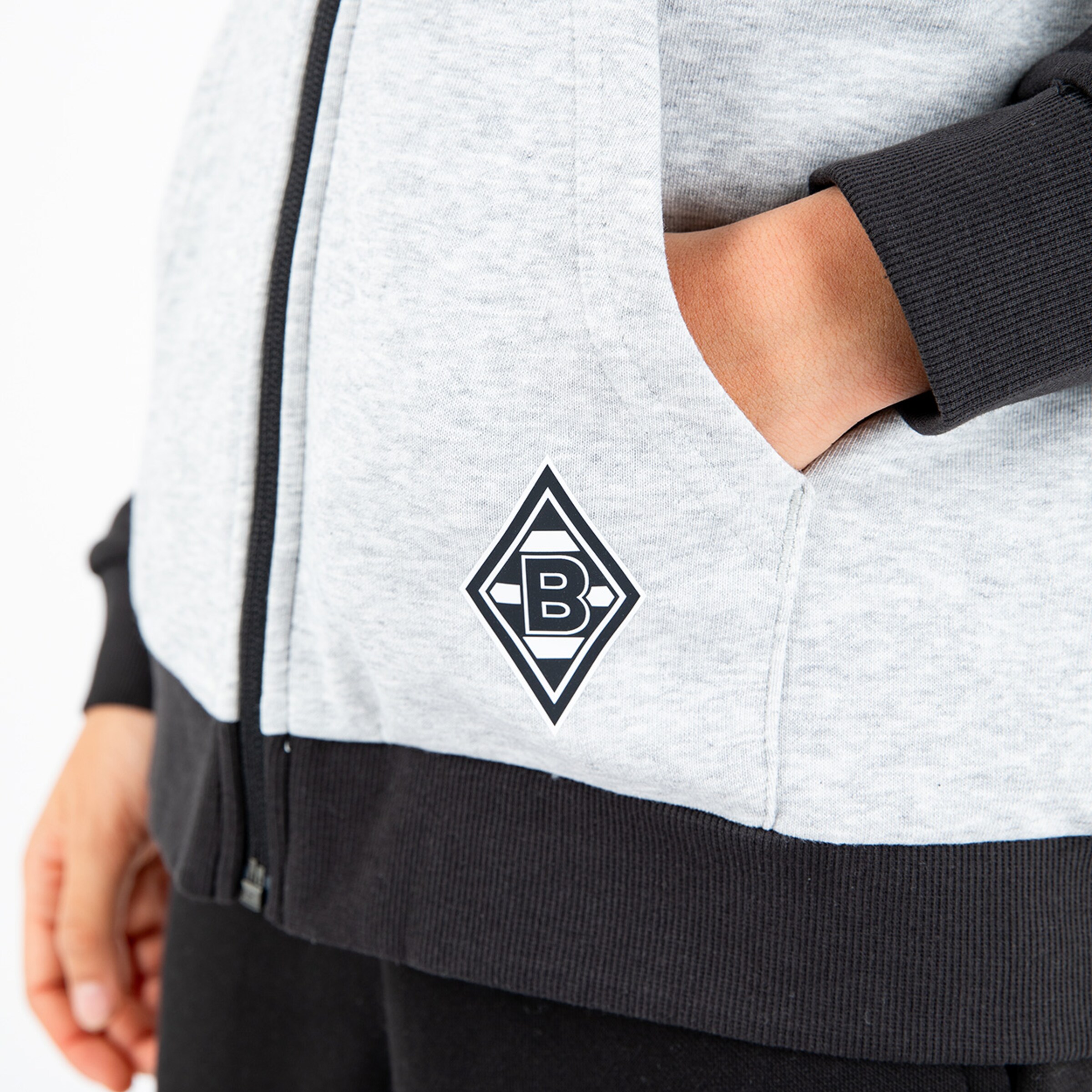 Gray-black jacket with Borussia Mönchengladbach logo on the pocket.