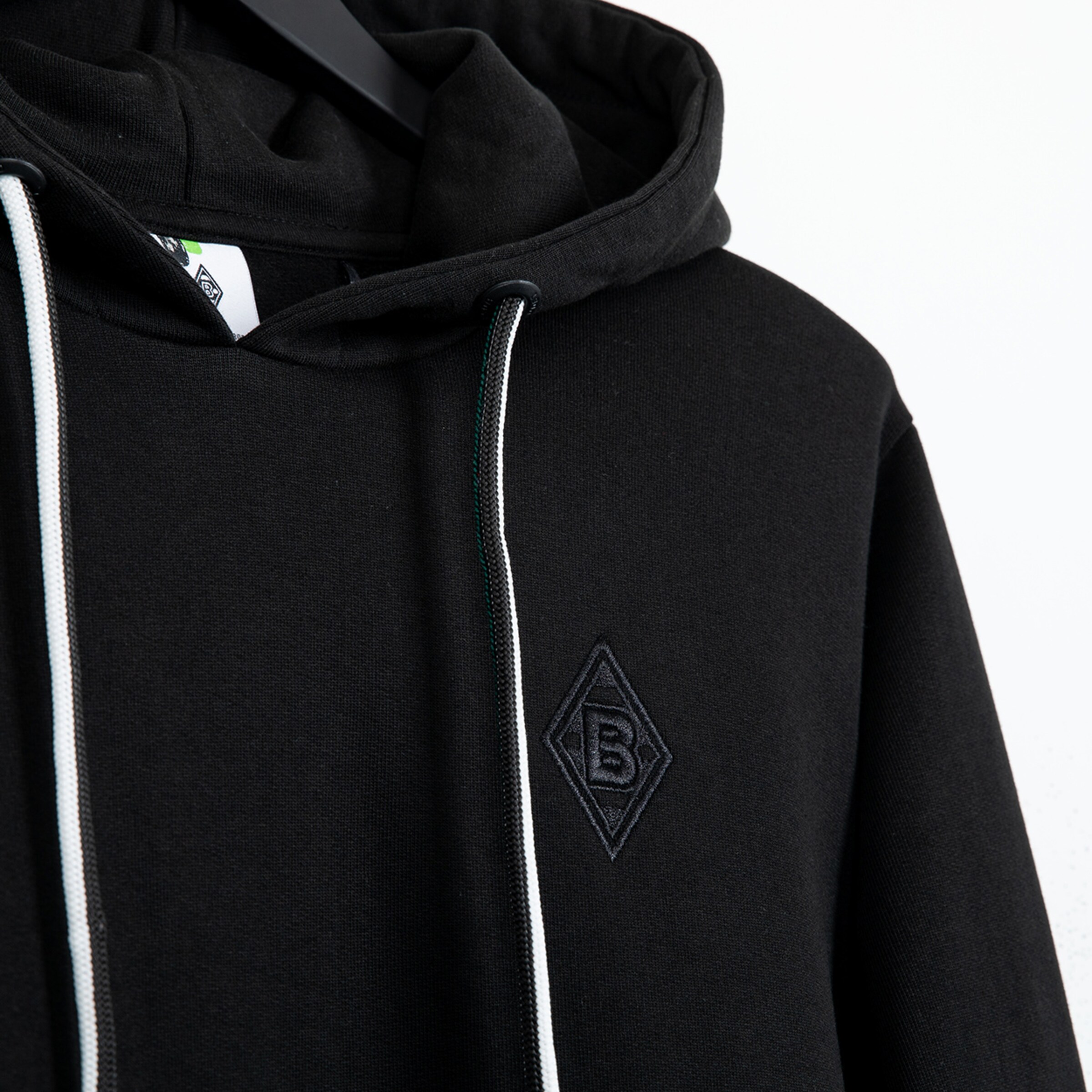 Black hoodie featuring embroidered Borussia Mönchengladbach logo on the left chest.