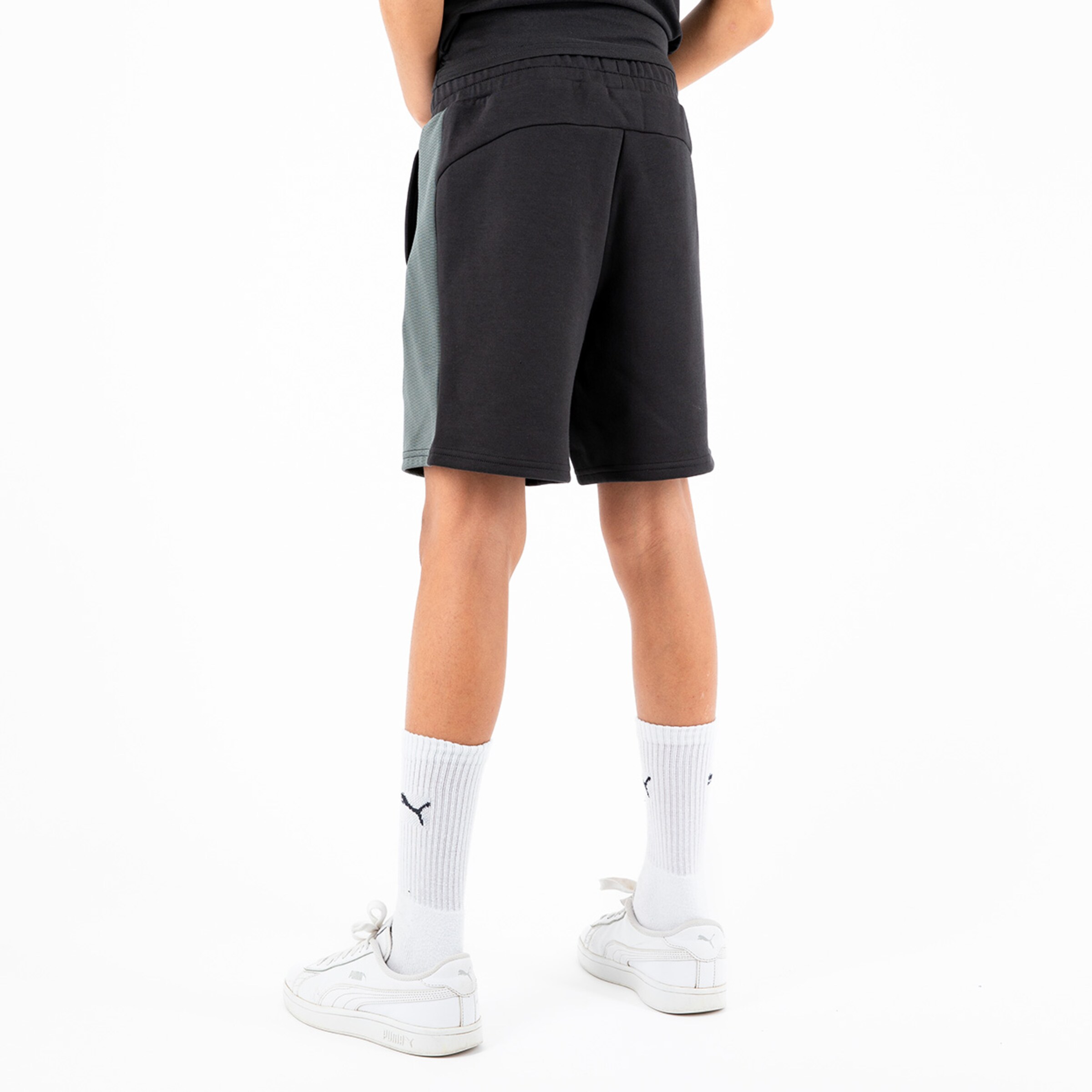 Black sports shorts with gray accents viewed from the back