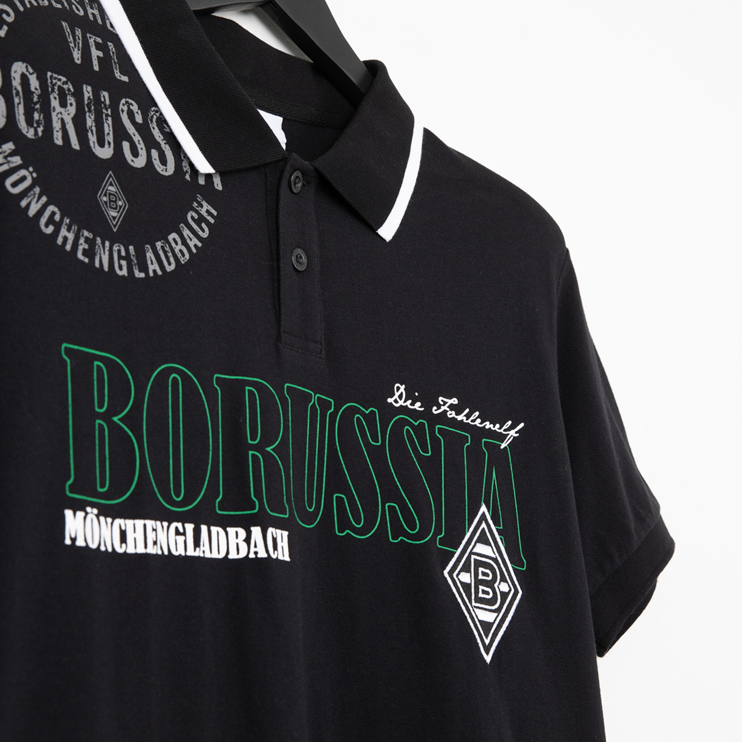 Black polo shirt with green text BORUSSIA MÖNCHENGLADBACH and various logos.