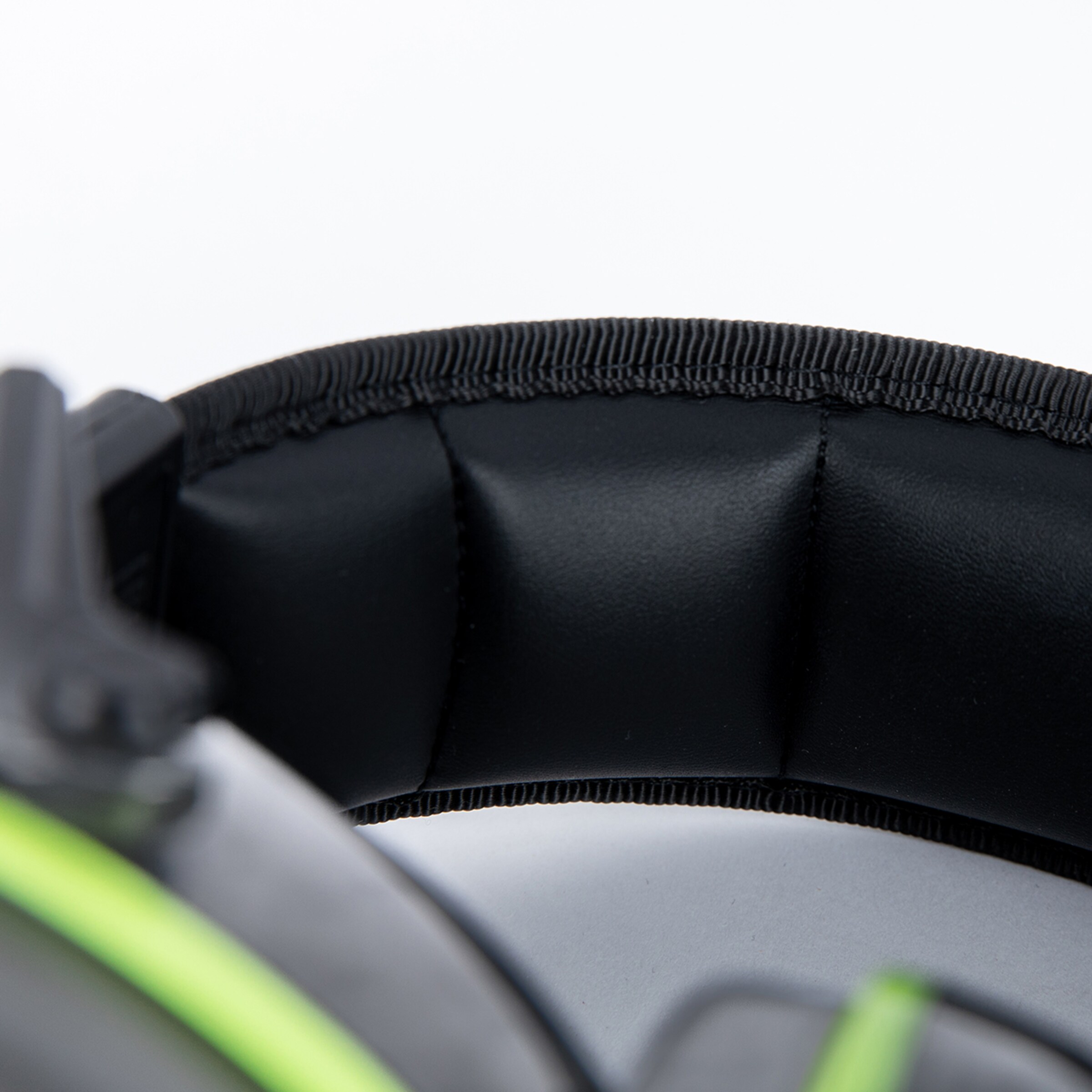 Close-up of headphones ear cushions with green accents.