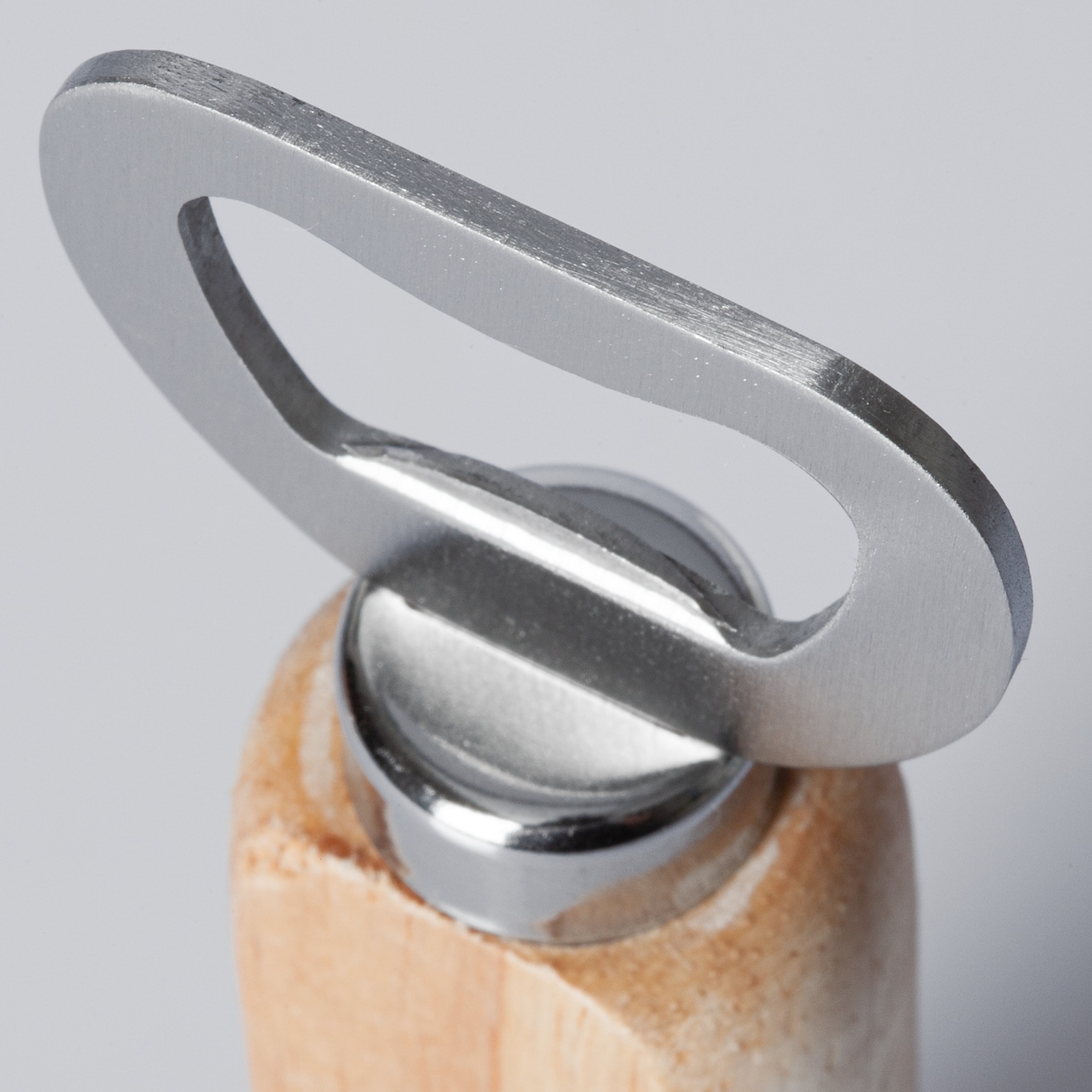 Close-up of a metal bottle opener with a brushed finish and a wooden handle against a neutral background.