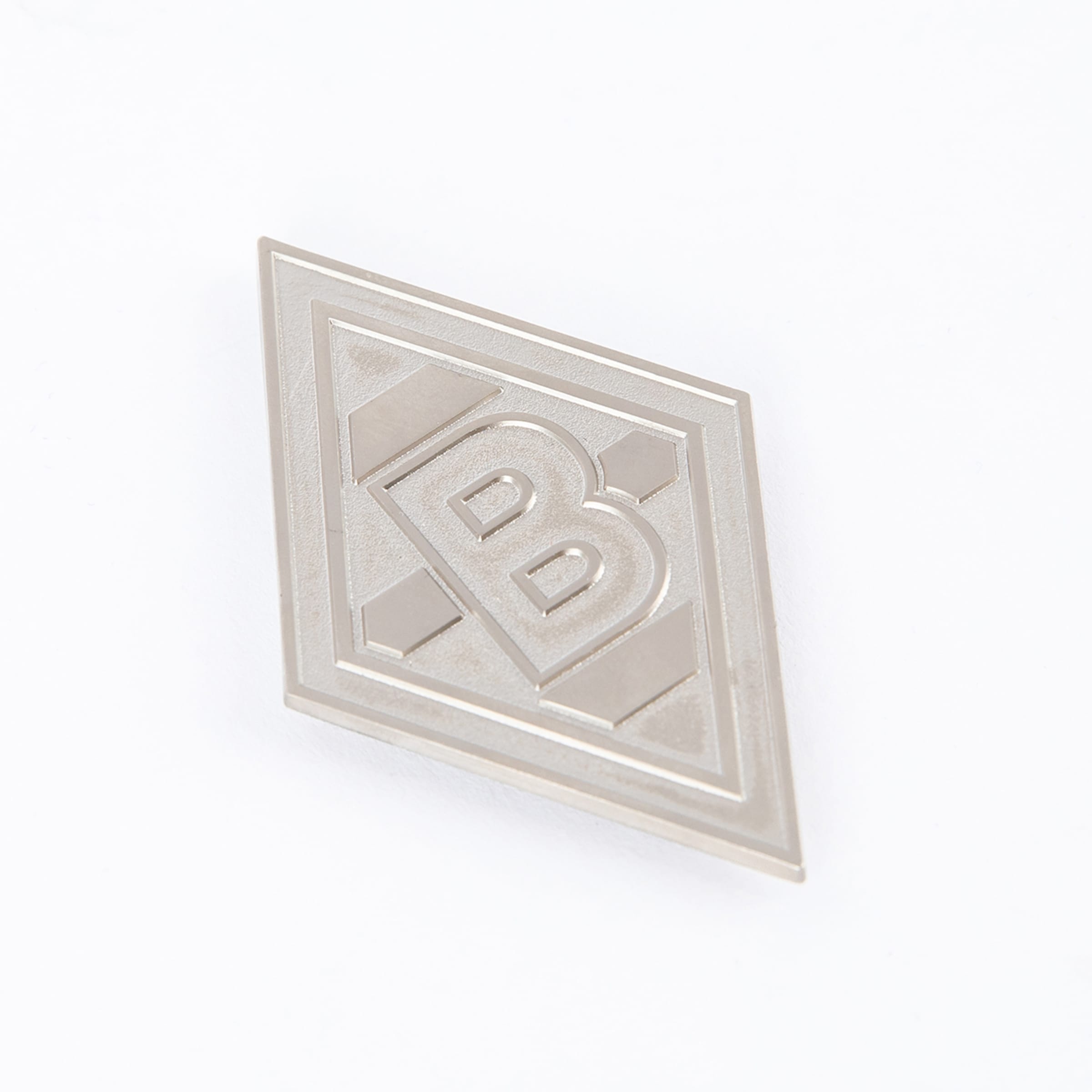Silver Borussia Mönchengladbach club badge in a diamond shape.