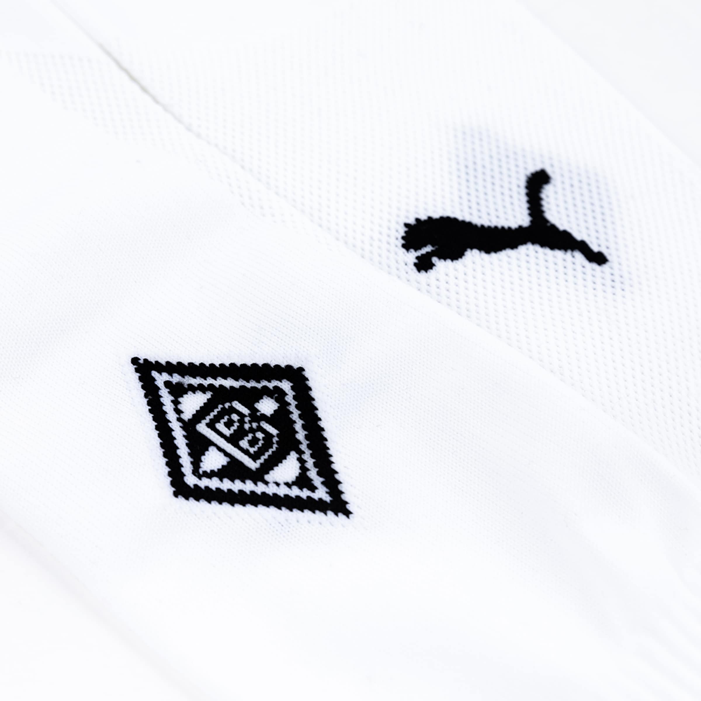 Close-up of a white jersey featuring the Puma logo and Borussia Mönchengladbach crest.