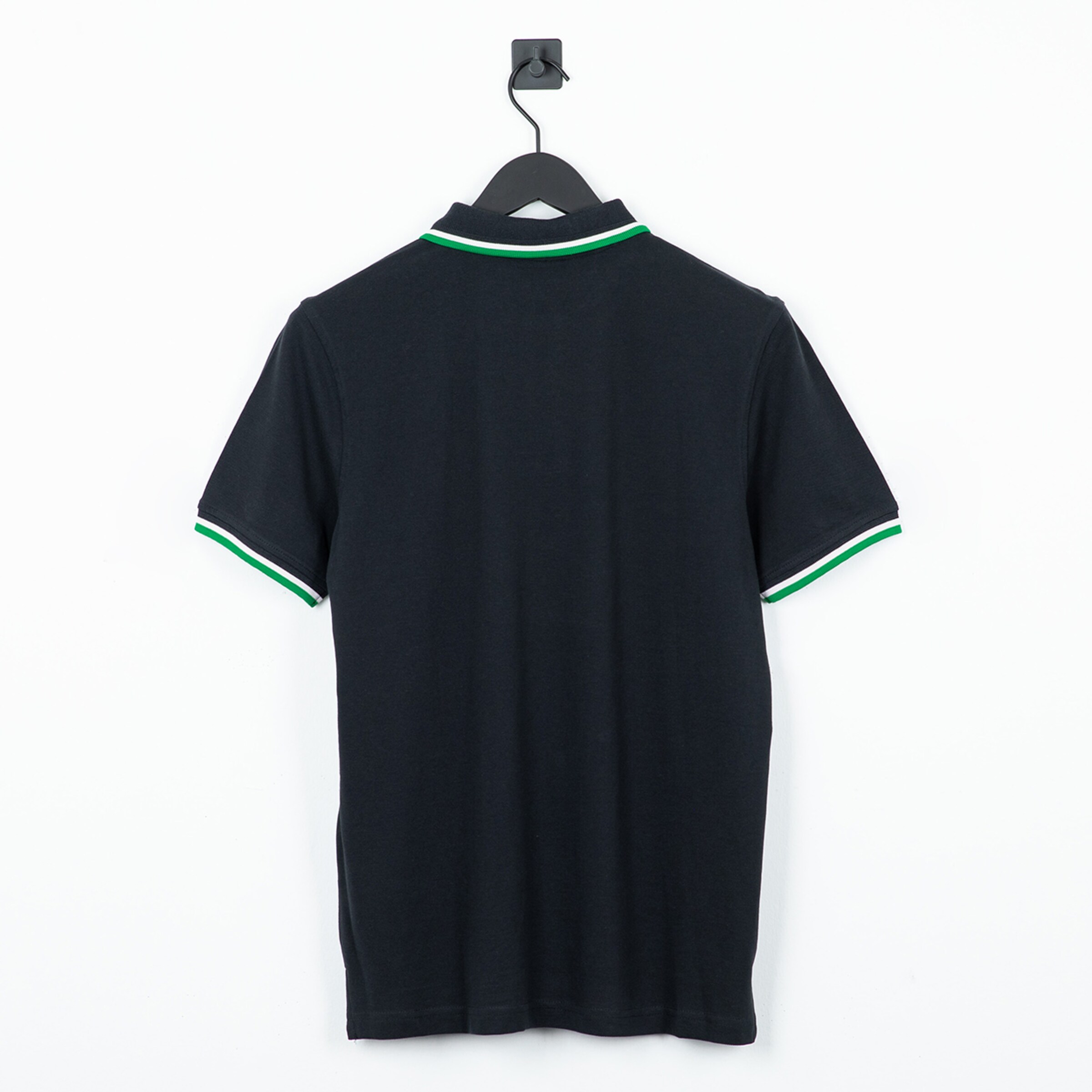 Black polo shirt with short sleeves and striped collar photographed from the back.