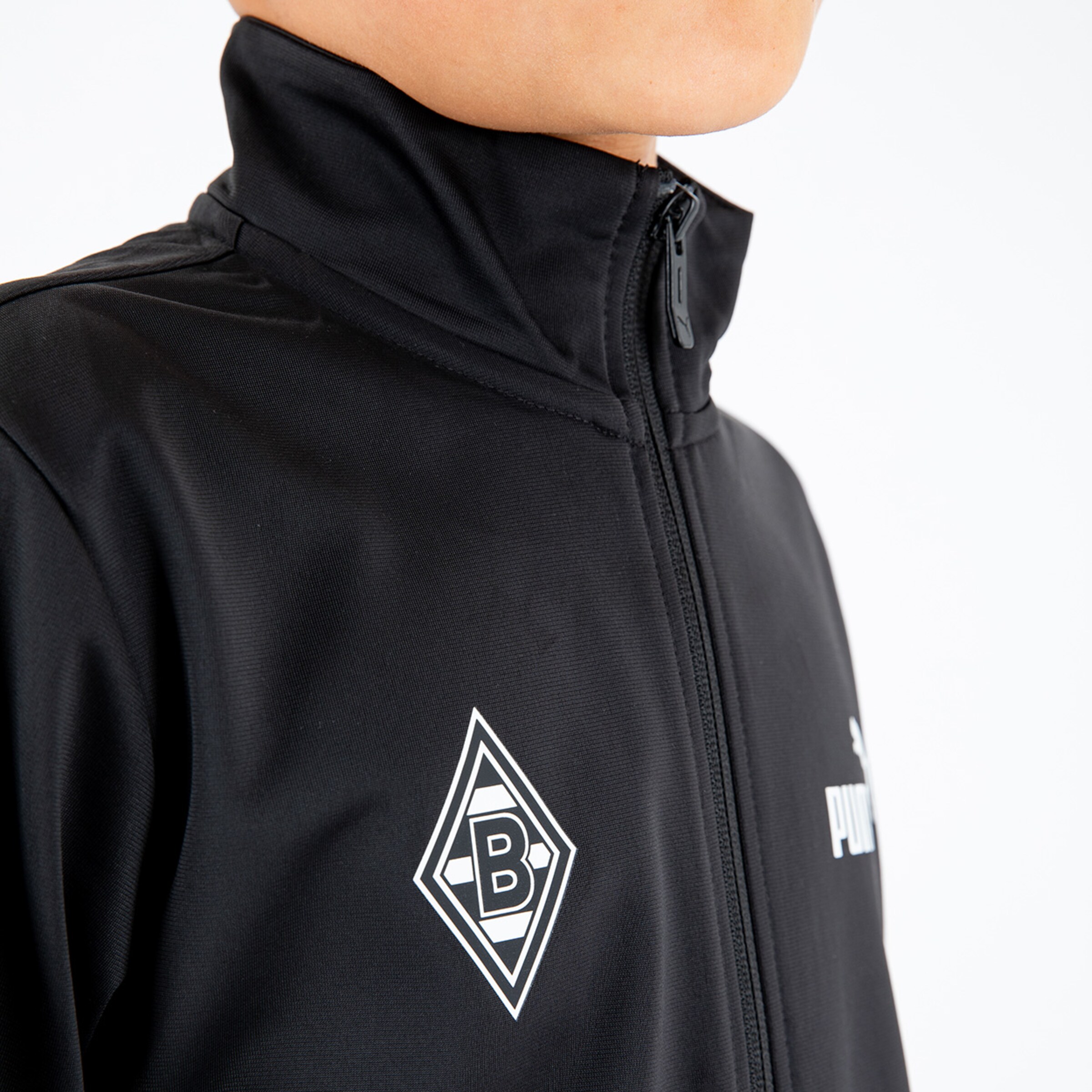 Young man wearing a black jacket with Borussia Mönchengladbach logo.
