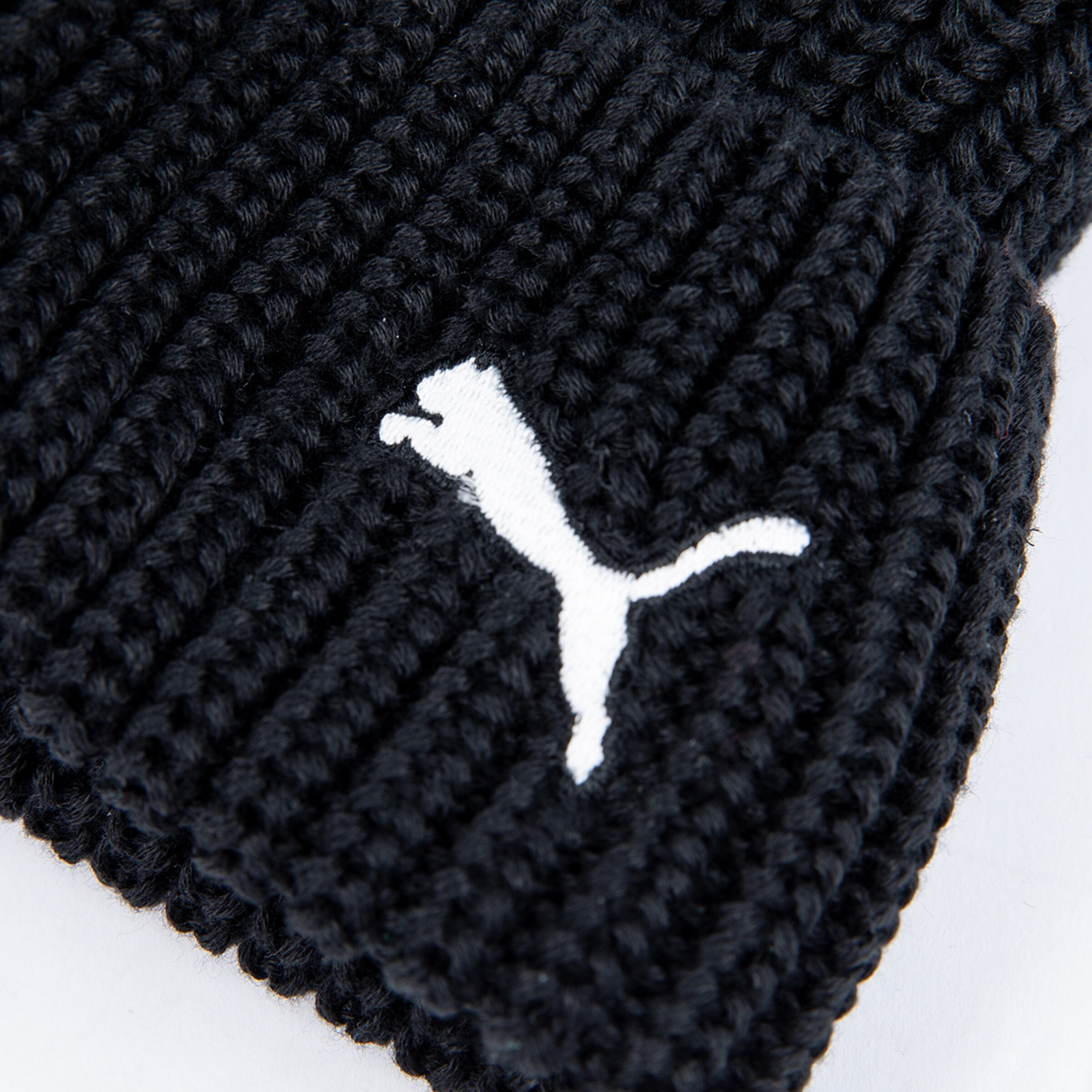 Black knitted beanie with white Puma logo.