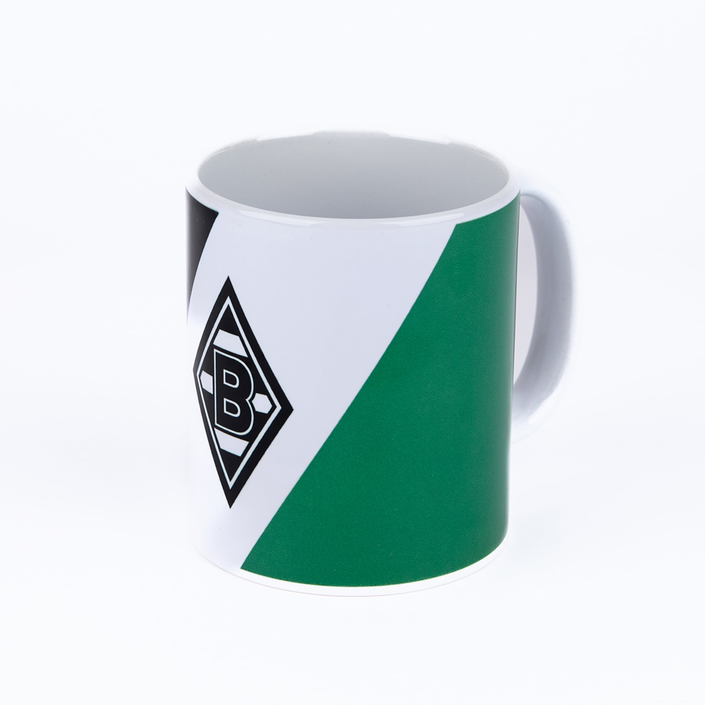 White mug featuring diagonal black, white, and green sections with the Borussia Mönchengladbach logo (diamond with B3). The white handle is visible on the right.