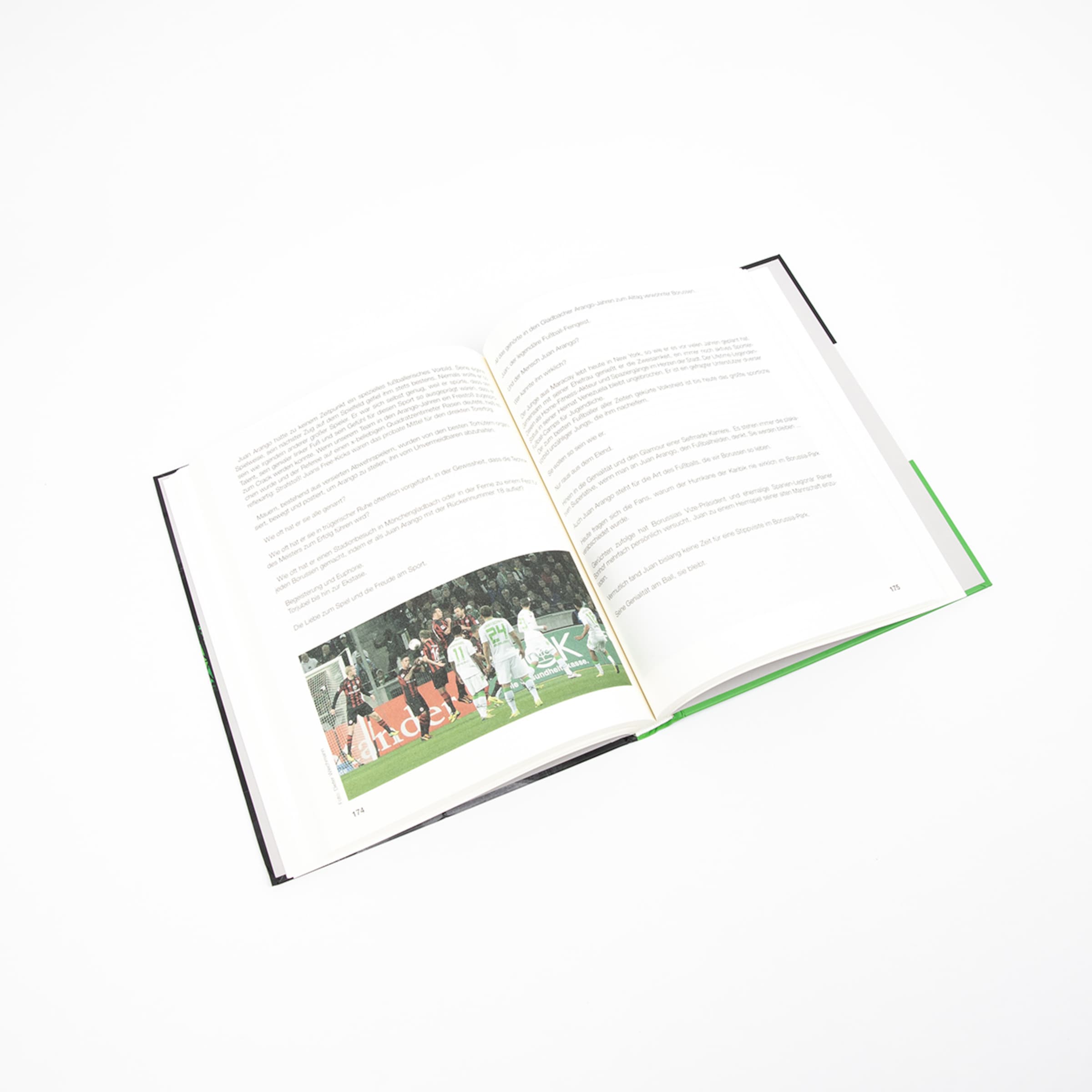 Open book about Juan Arango with text and a soccer photo on pages 174 and 175 against a white background.