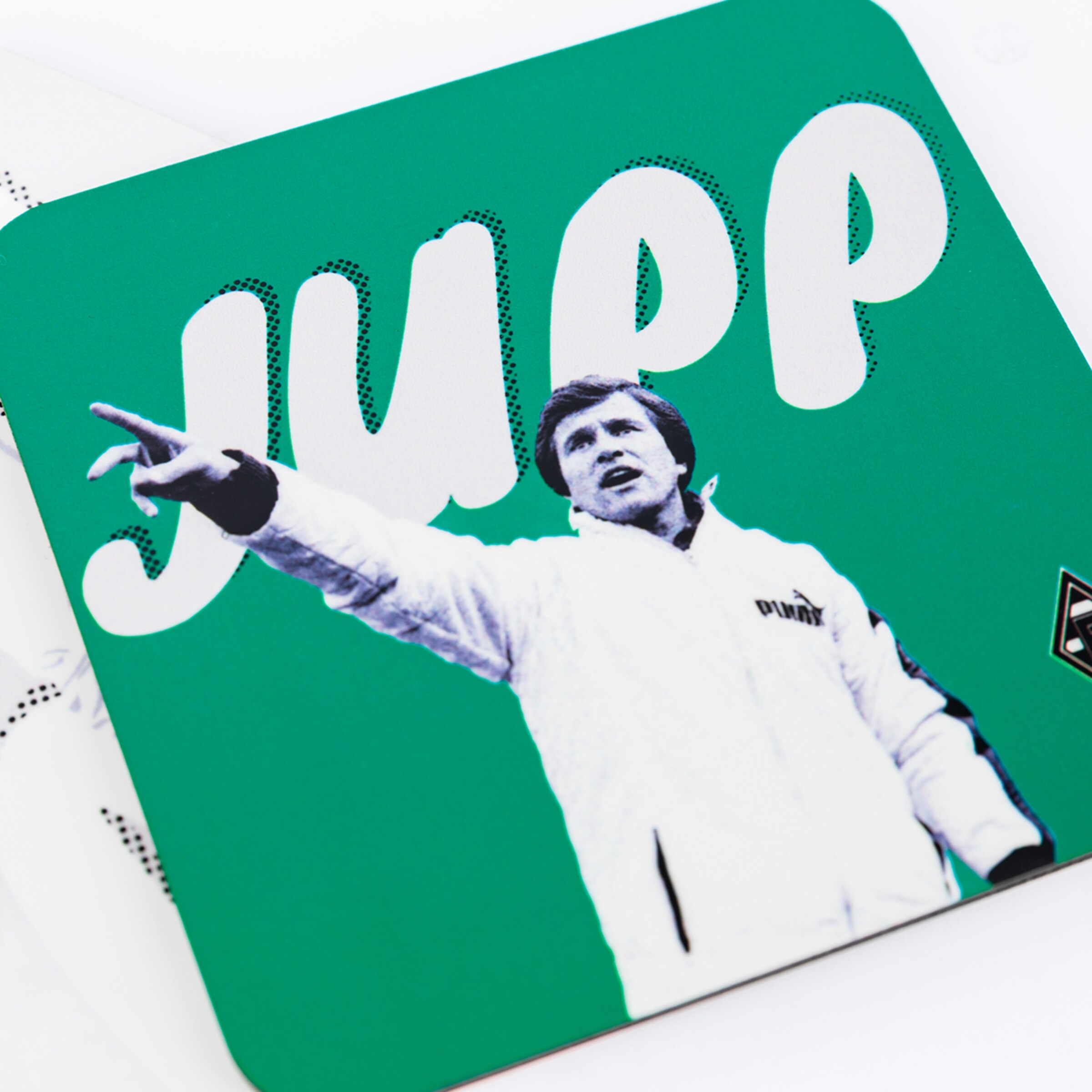 Jupp Heynckes gestures in a white jacket with the name JUPP in the background.