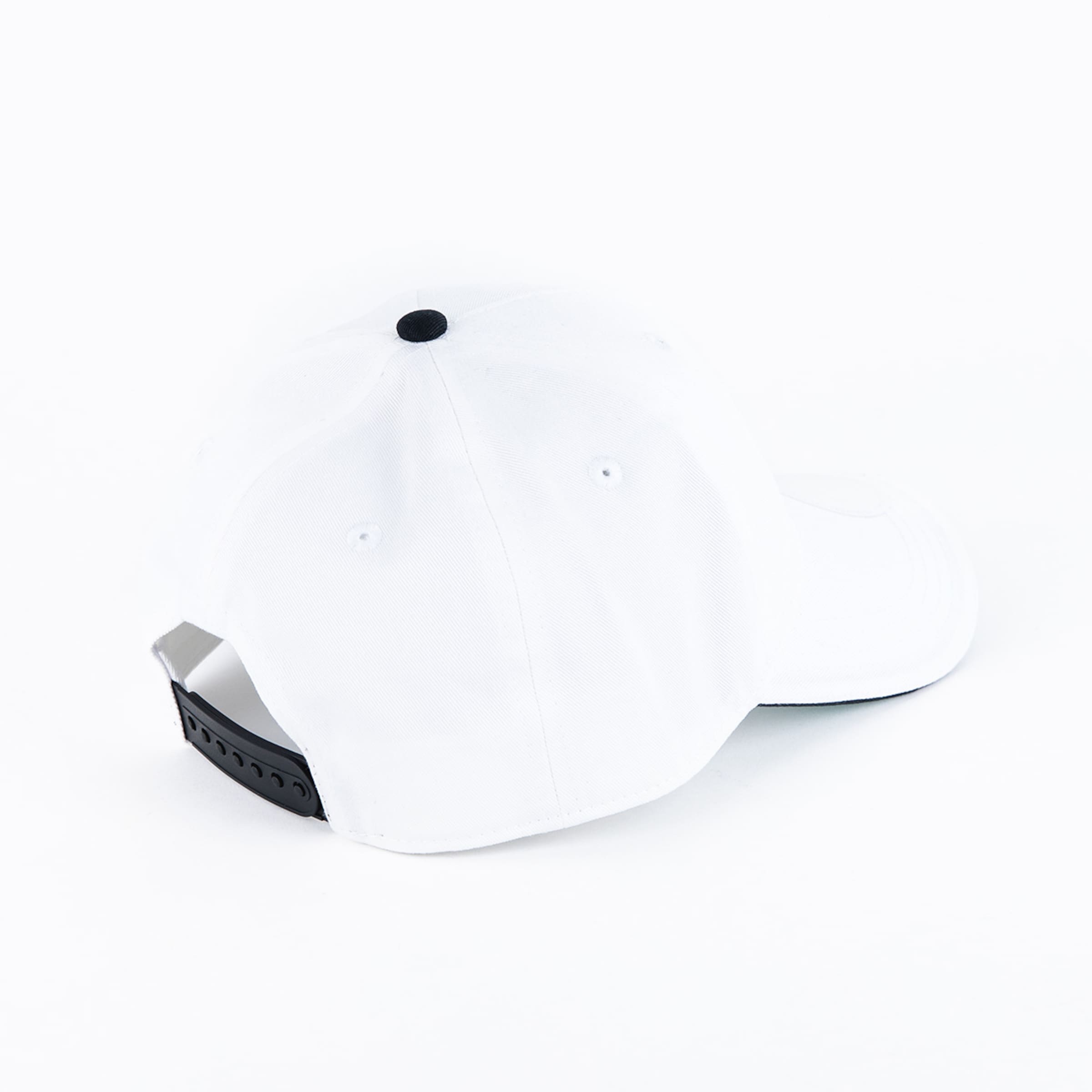 Rear view of a white baseball cap featuring a black top button and adjustable snapback closure against a white background.