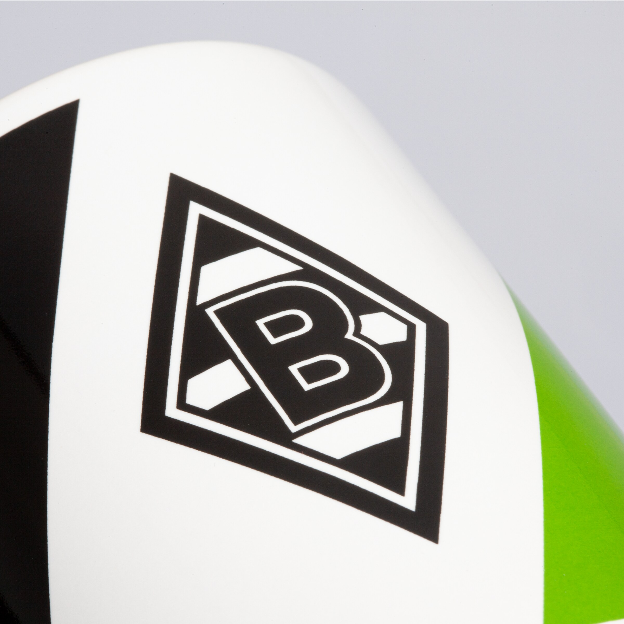 Close-up of the Borussia Mönchengladbach logo on a soccer shoe.