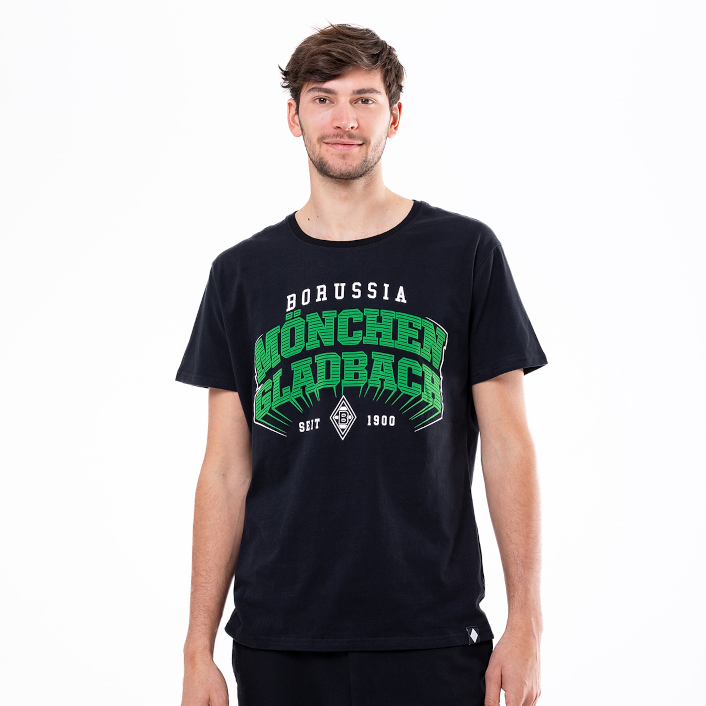 A young man wearing a black t-shirt featuring the text Borussia Mönchengladbach in green design.