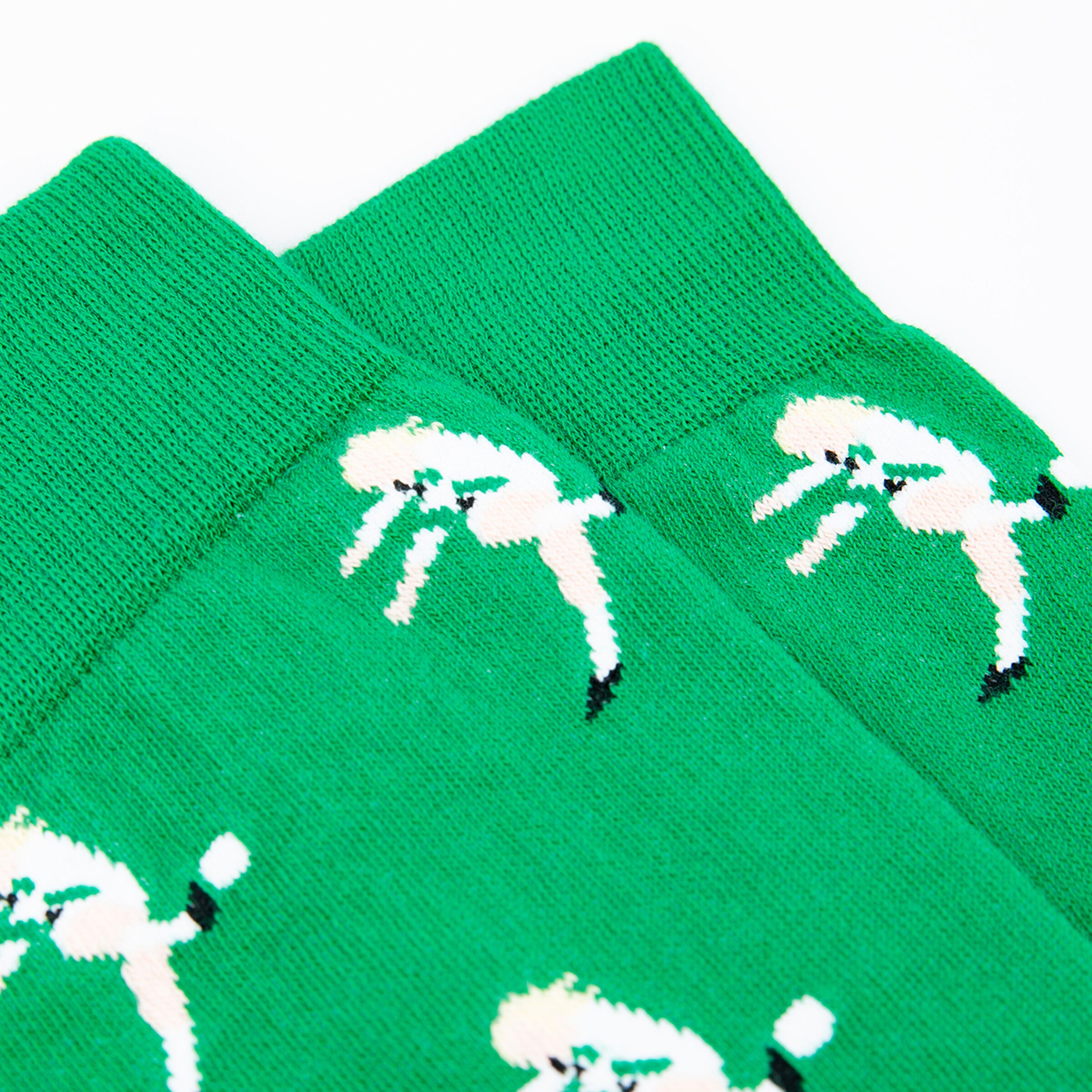Green socks featuring white poodle designs