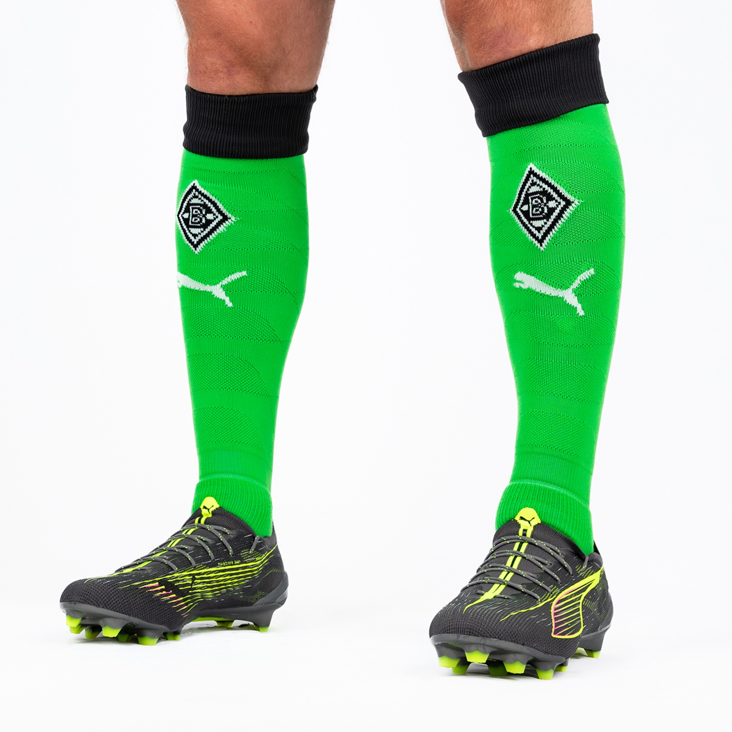 Green soccer socks with black cuff and Borussia Mönchengladbach logo.