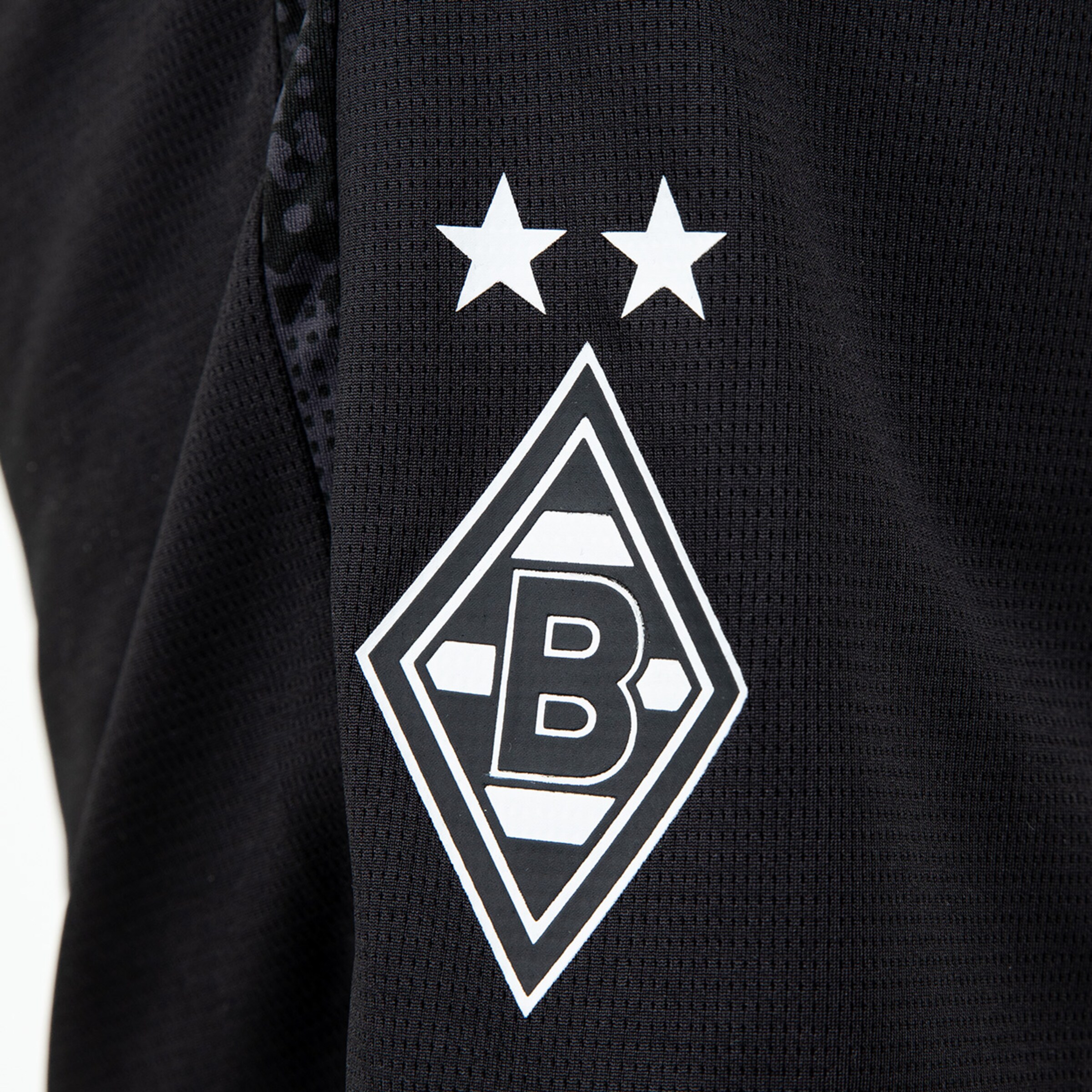 Schwarze Trikot-Seite mit Borussia Mönchengladbach Logo und zwei Sternen.