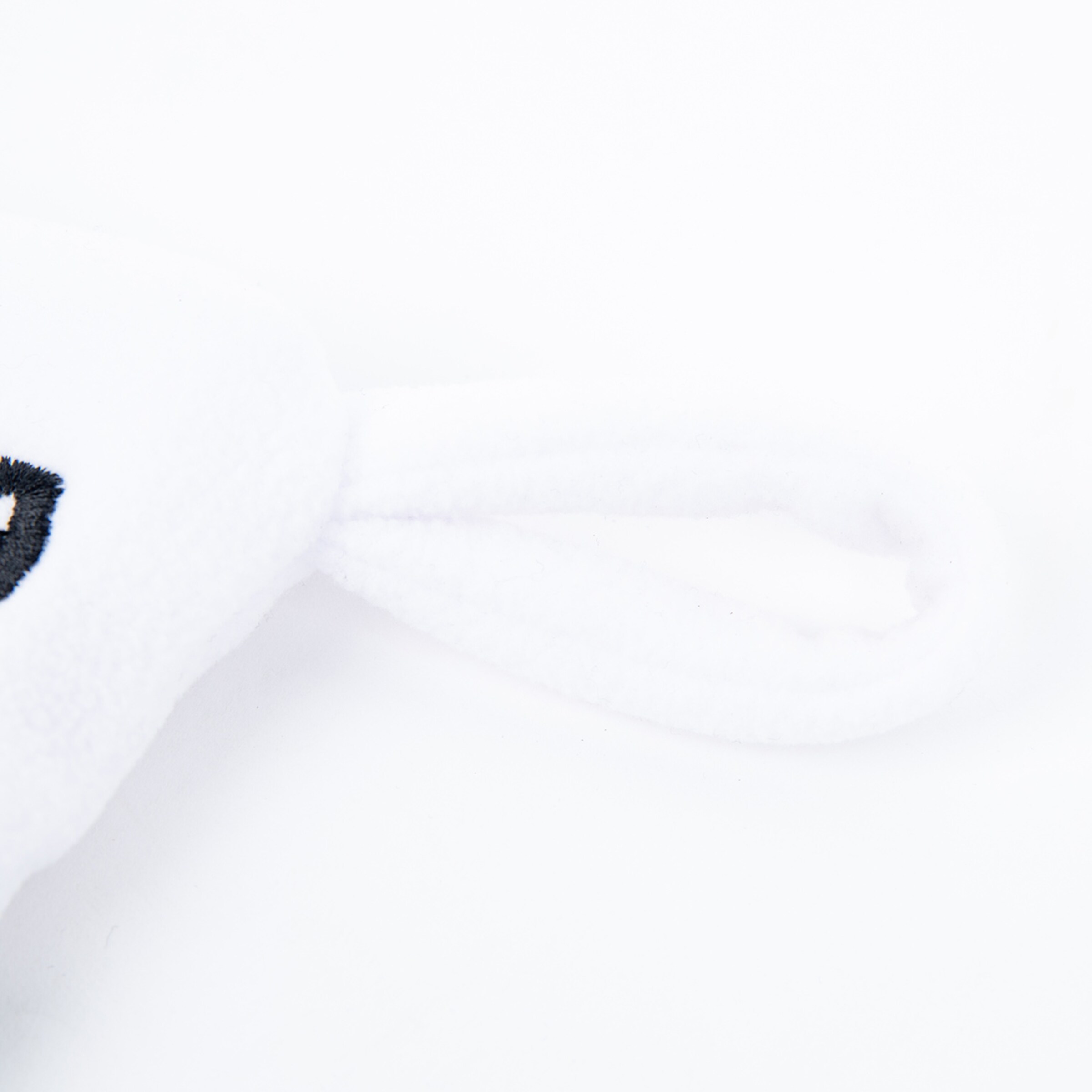 White plush mascot with black accents.