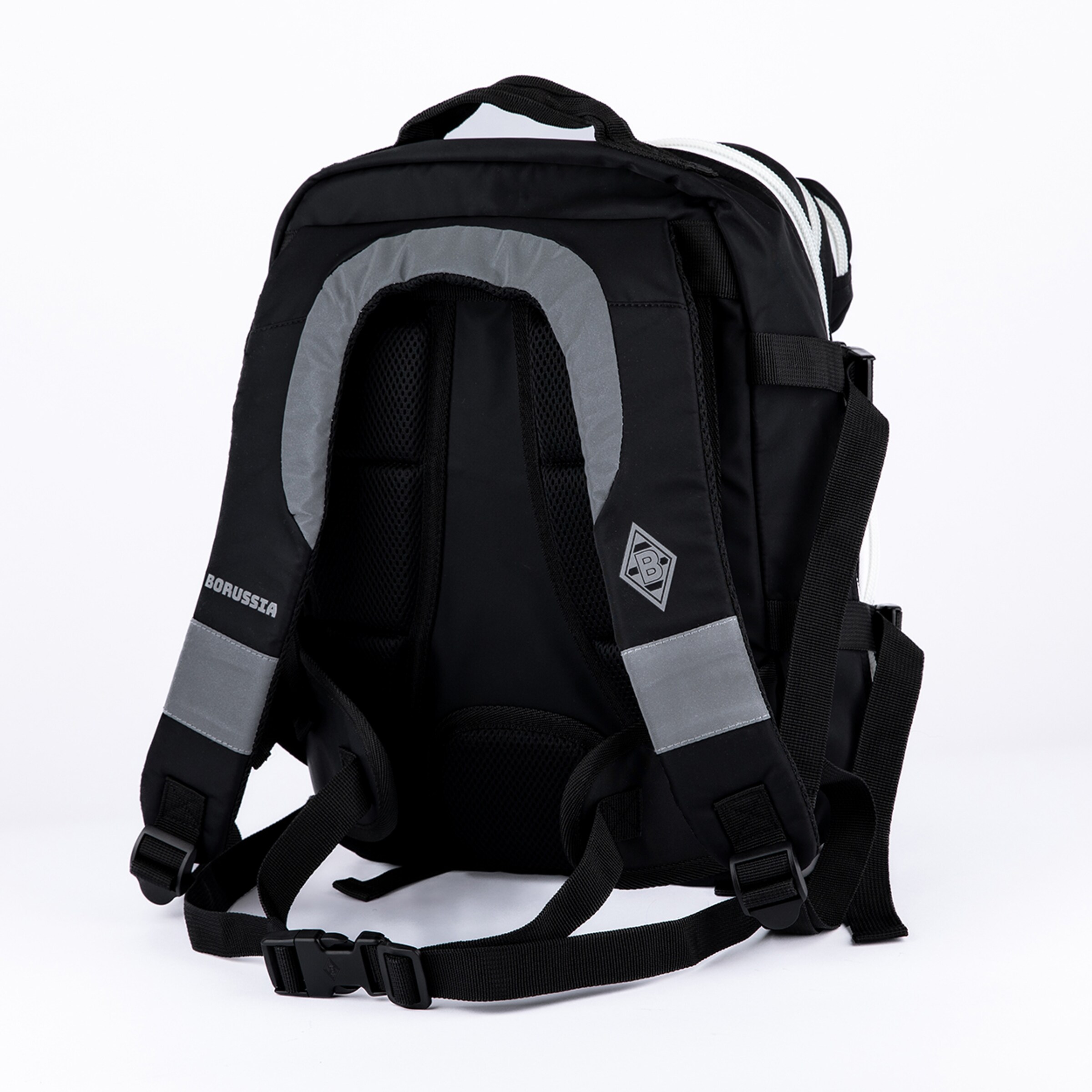Black backpack, back view. Features padded shoulder straps with 'BORUSSIA' text and Borussia Mönchengladbach logo, grey reflective strips, padded back panel, and white side stripes.