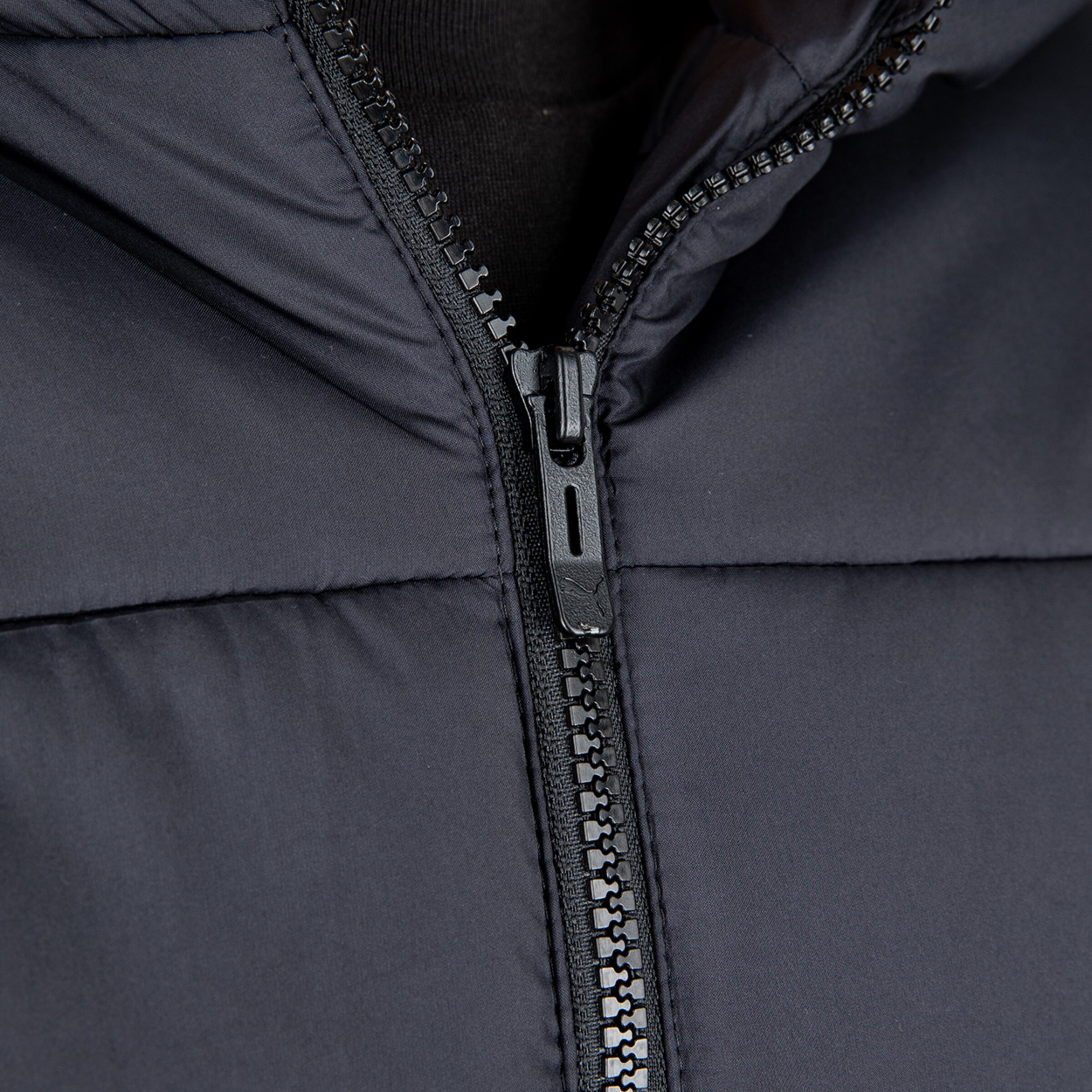 Close-up of a zipper on a dark jacket.