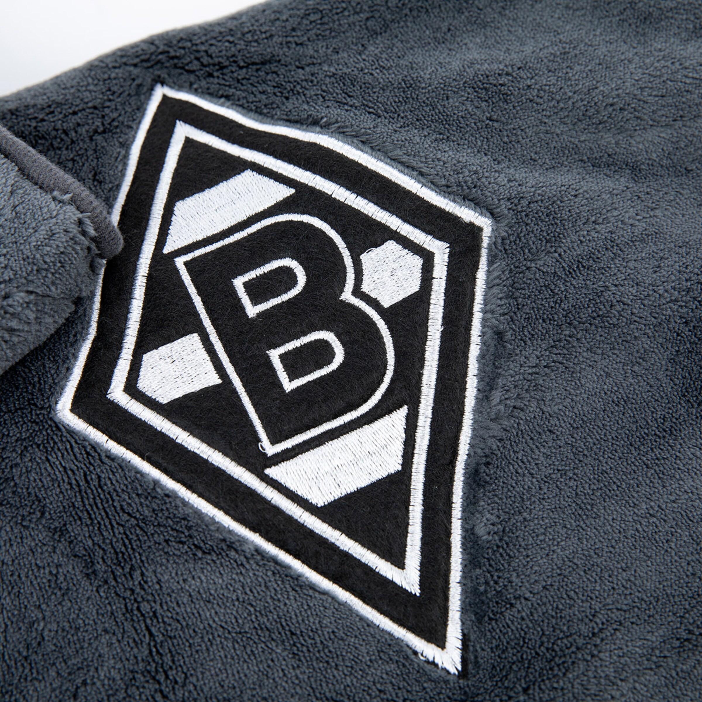 Graues weiches Material mit dem Borussia Mönchengladbach Logo in der Mitte.