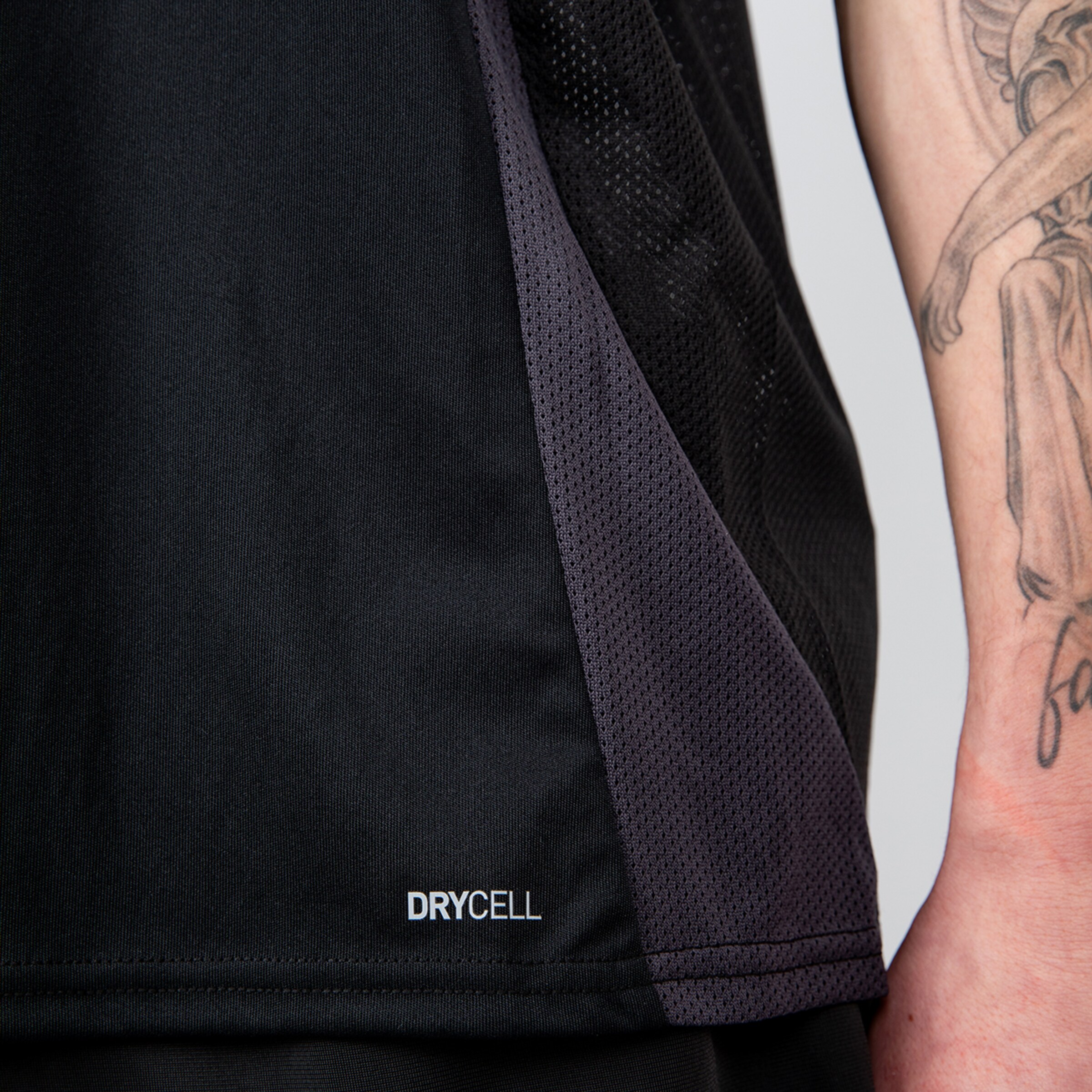 Close-up of a gray sports top featuring DryCell technology.