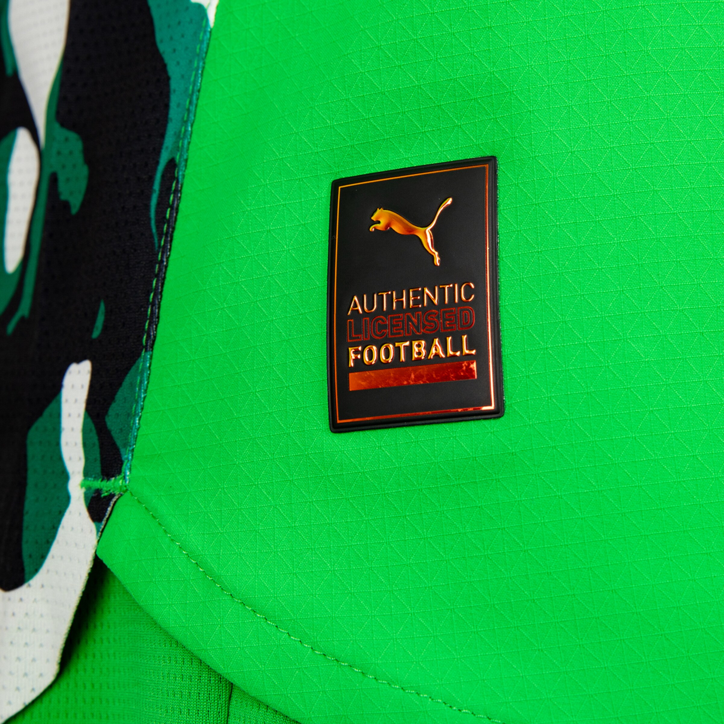 Authentic licensed logo on a green sports jersey.
