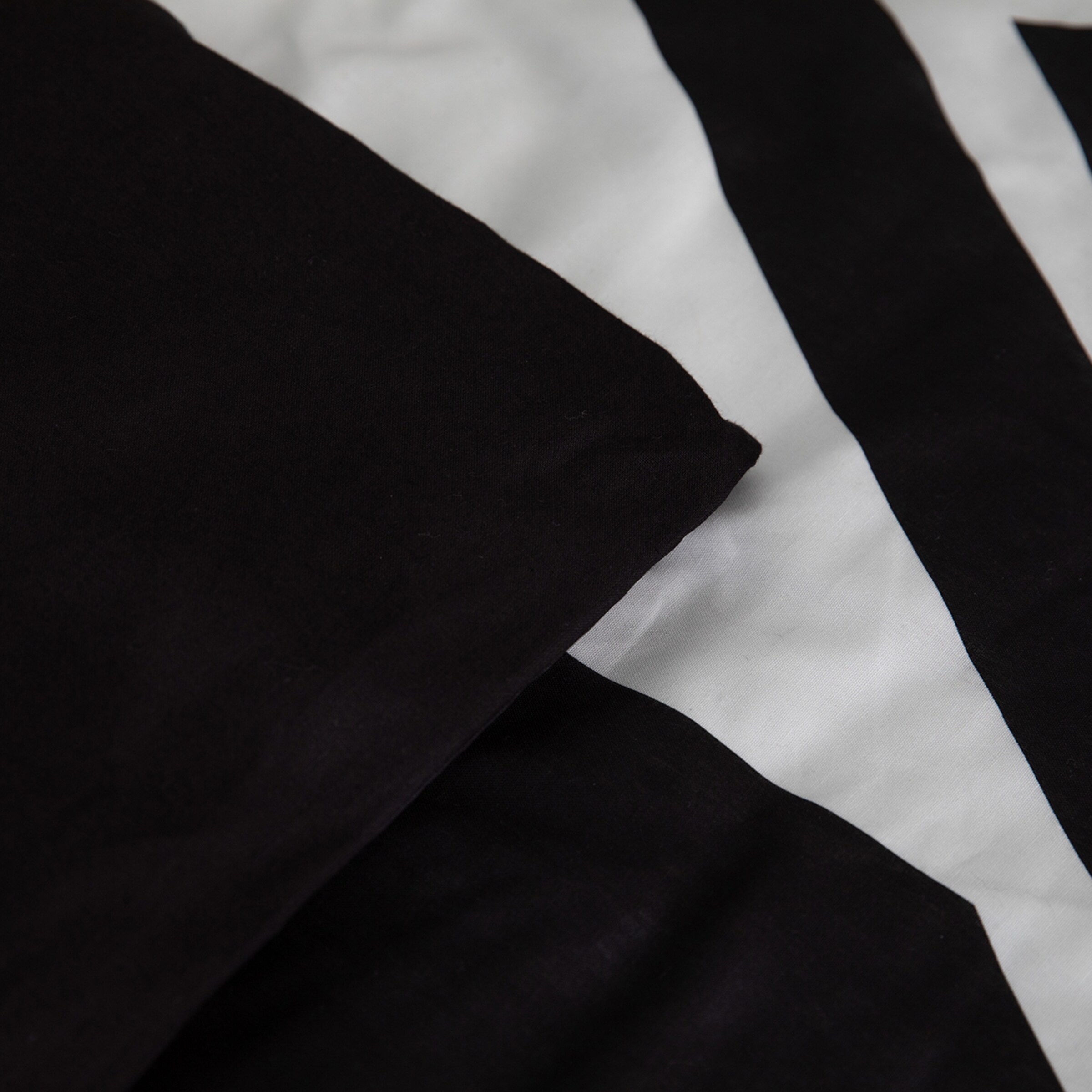 Schwarzes und weißes Stoffmuster mit geometrischen Formen.