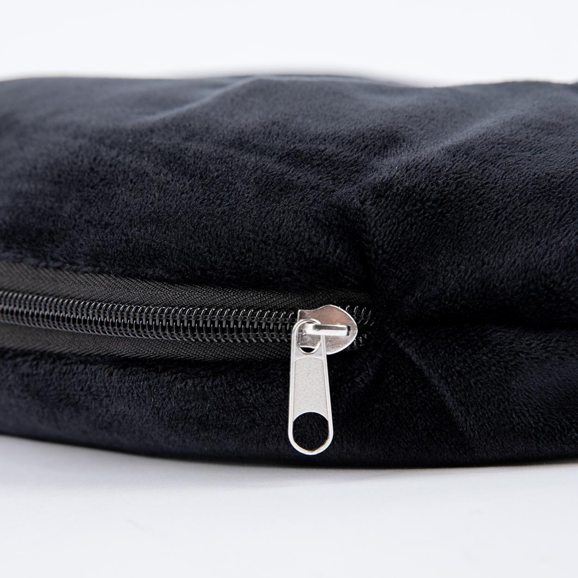 Black round bag with a silver zipper.