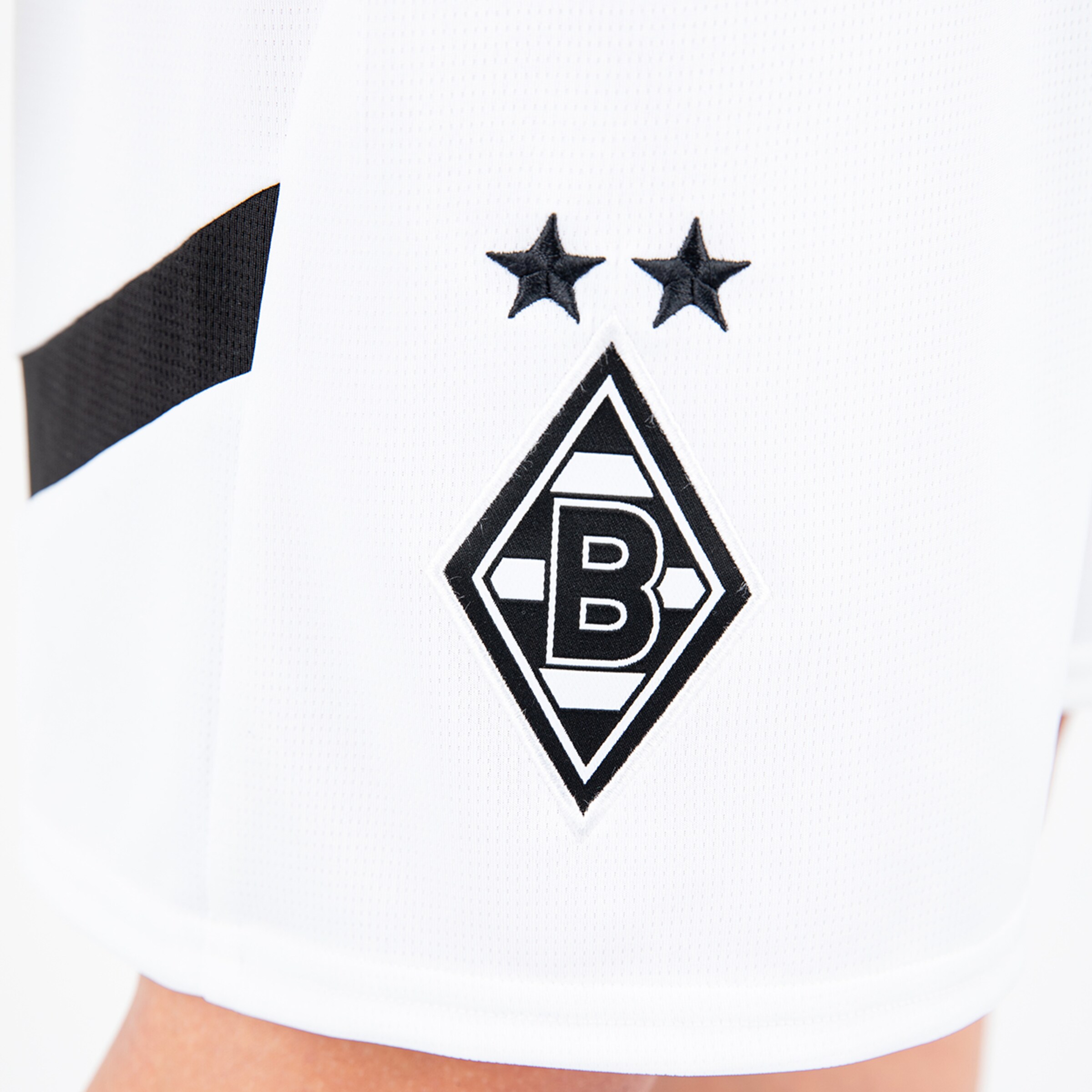 Close-up of Borussia Mönchengladbachs emblem on a white jersey.
