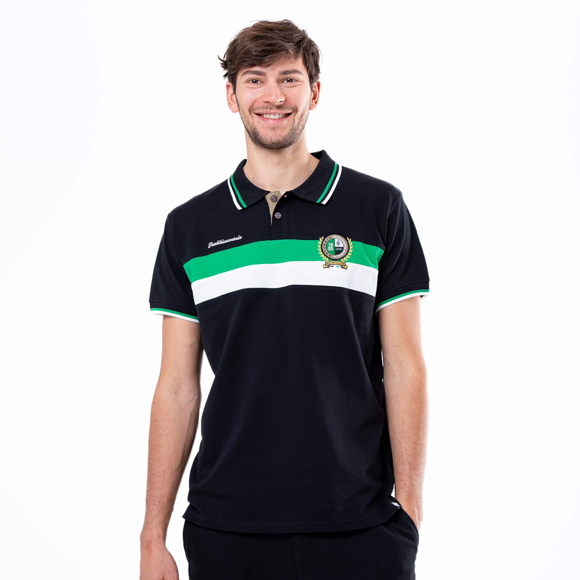 A young man smiles in a polo shirt with striped design and logo.