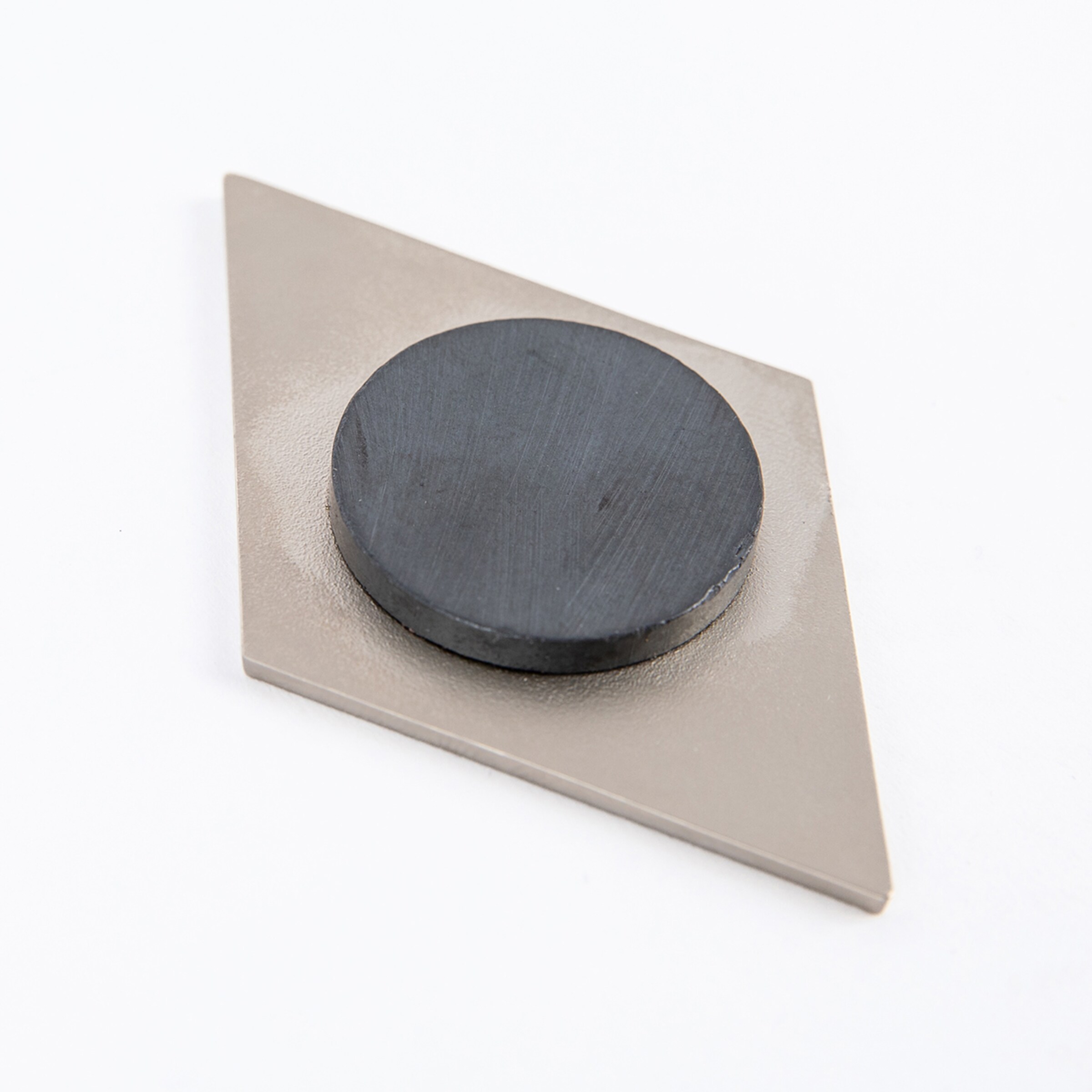 Magnet in diamond-shaped holder with a round black surface