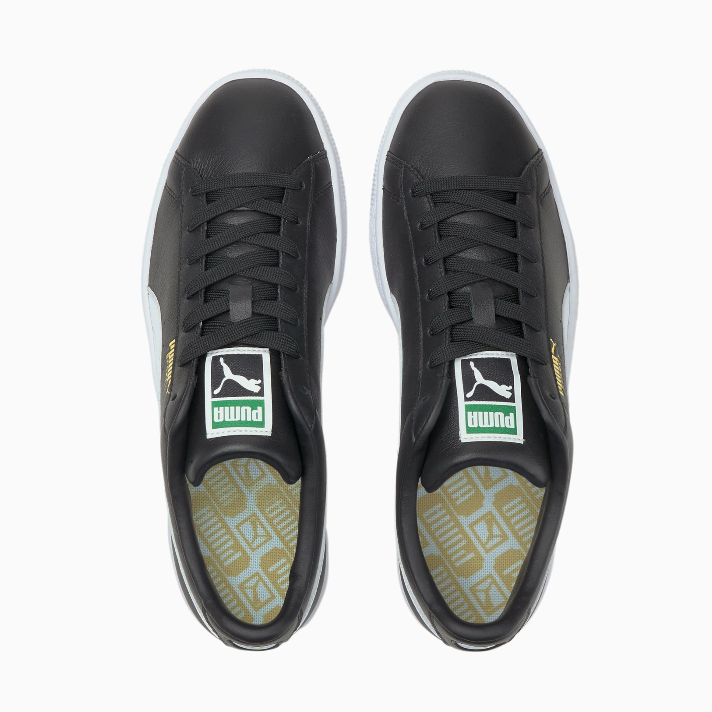 Schwarze Sneakers von Puma mit flachen Schnürsenkeln und grünem Logo.