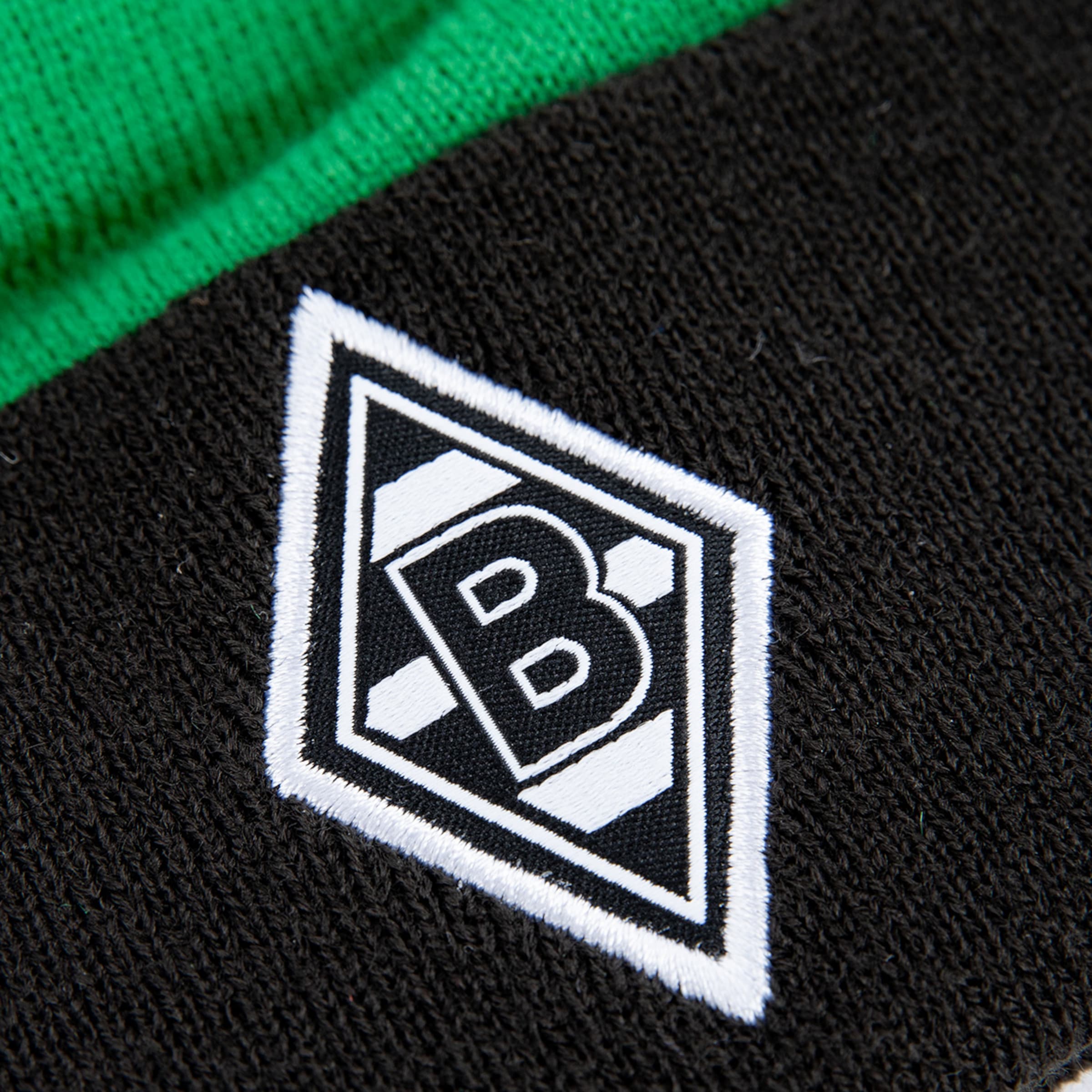 The Borussia Mönchengladbach logo featuring a black and white design on fabric.