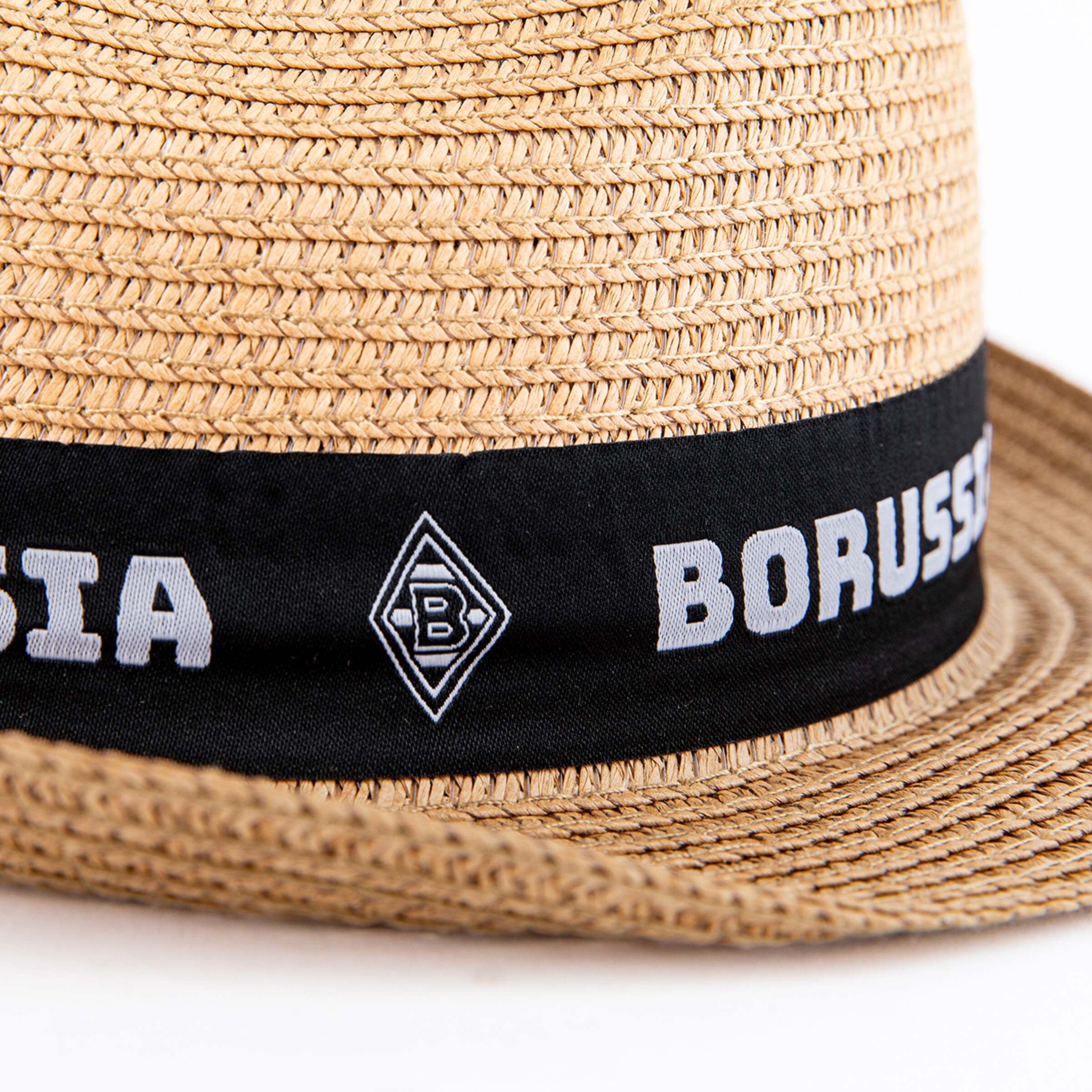 Close-up of a straw hat with a black band featuring "BORUSSIA" text and the Borussia Mönchengladbach club logo.