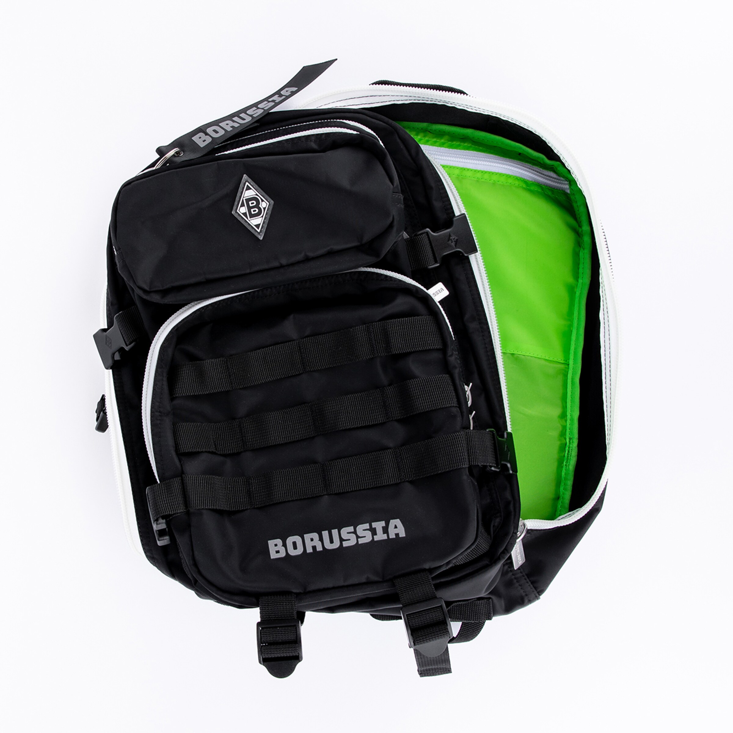 Black Borussia Mönchengladbach backpack, photographed from above and partially open to reveal the bright green lining. The club logo is visible on the top pocket, and "BORUSSIA" text on a strap and the bottom pocket.