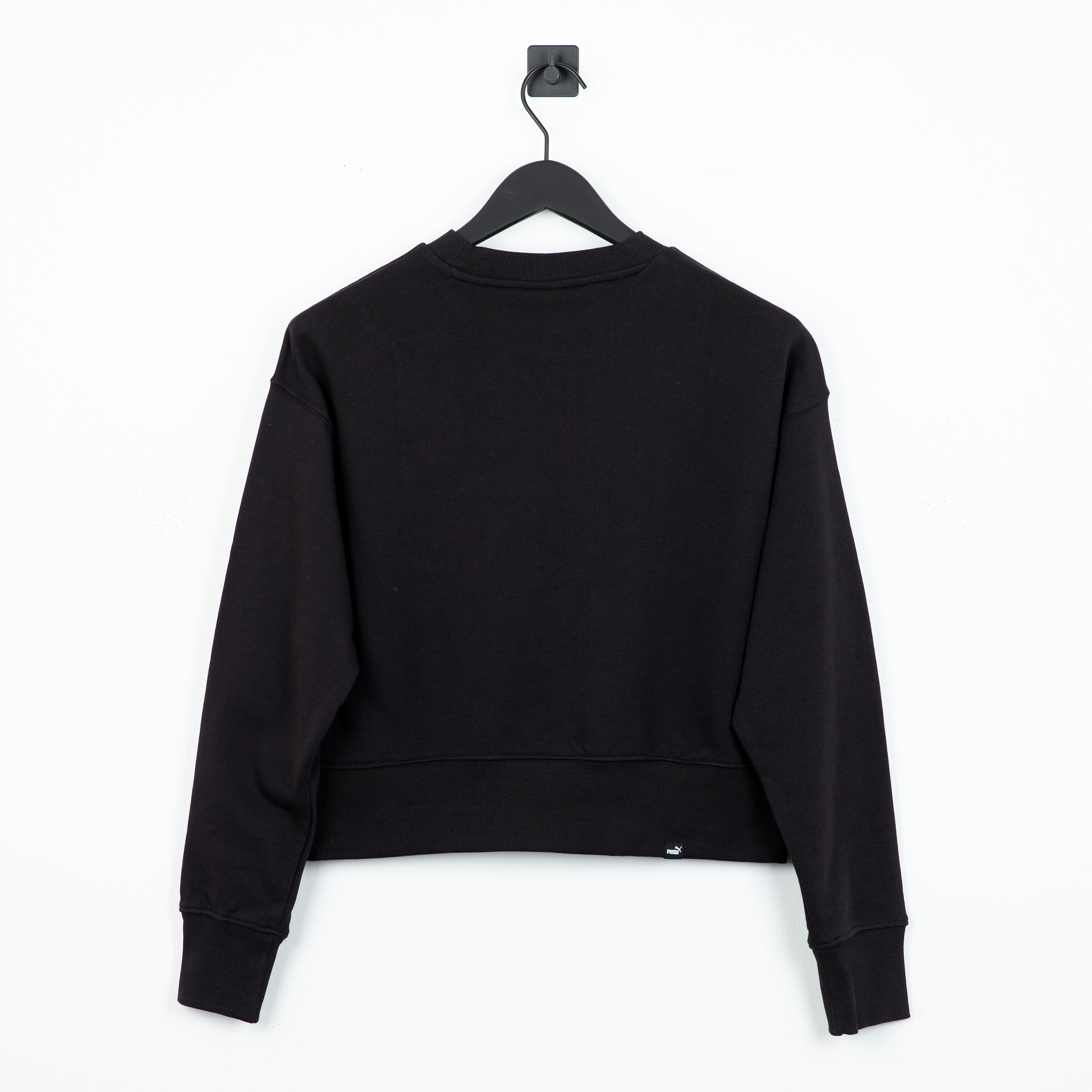 Black cropped sweatshirt on a hanger back view.