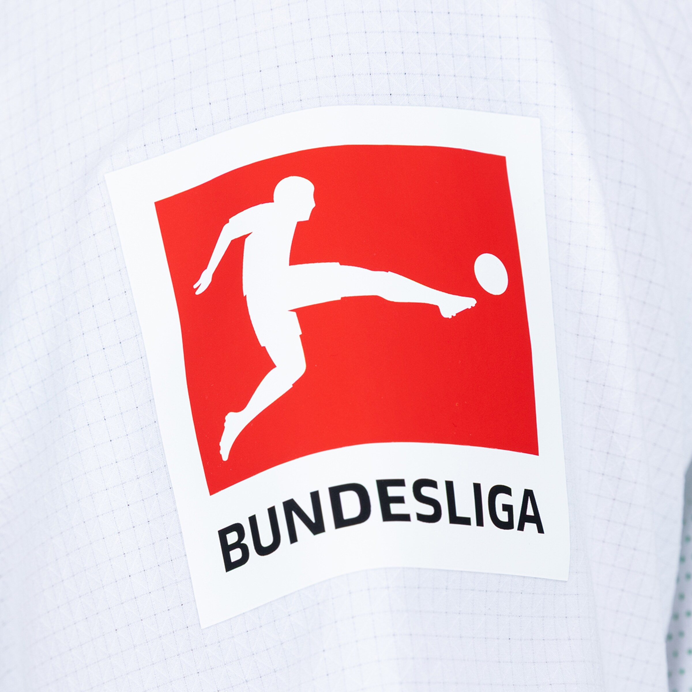 Bundesliga logo on white fabric: Red square with a white silhouette of a player kicking a ball and black "BUNDESLIGA" lettering below.