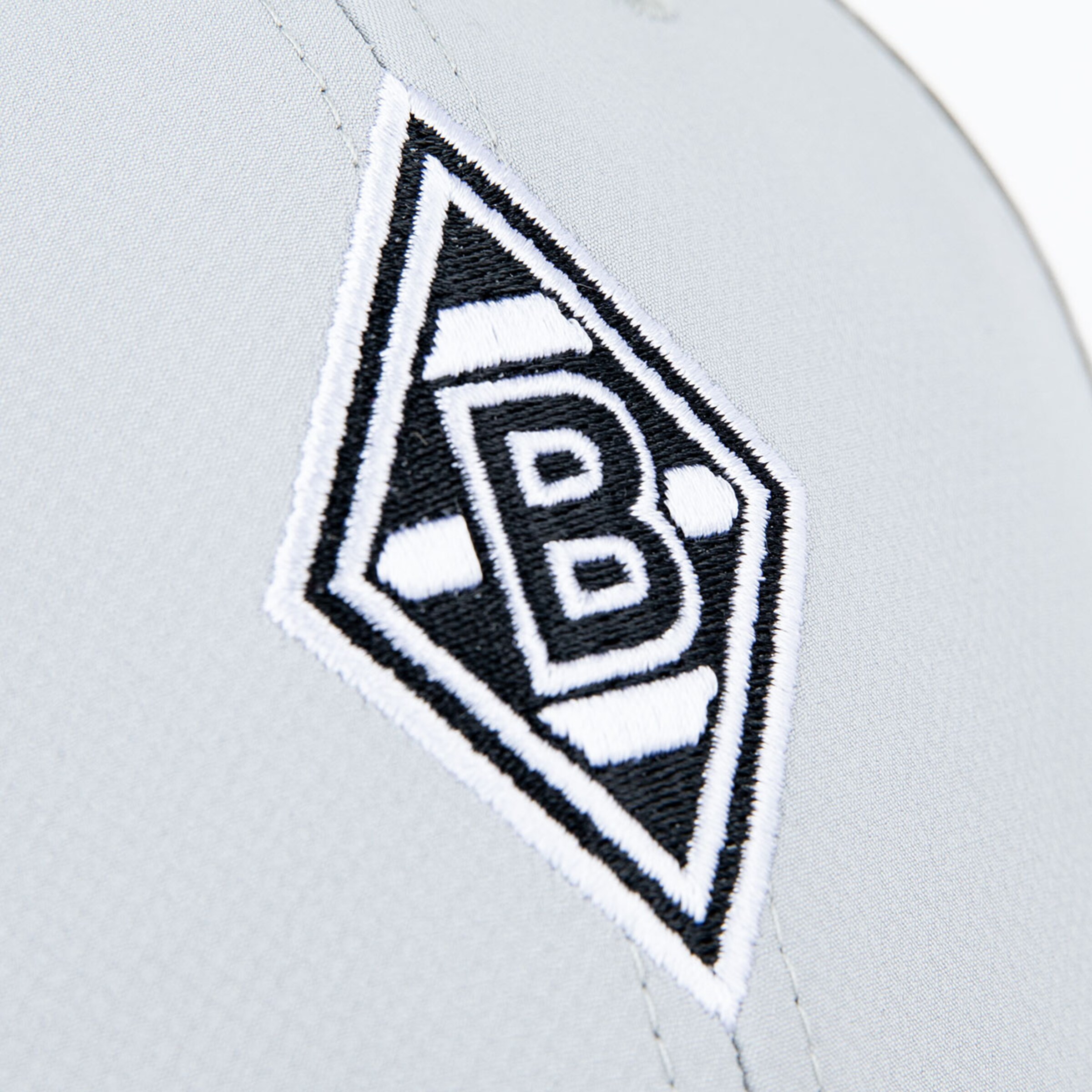 Logo of Borussia Mönchengladbach on gray fabric.