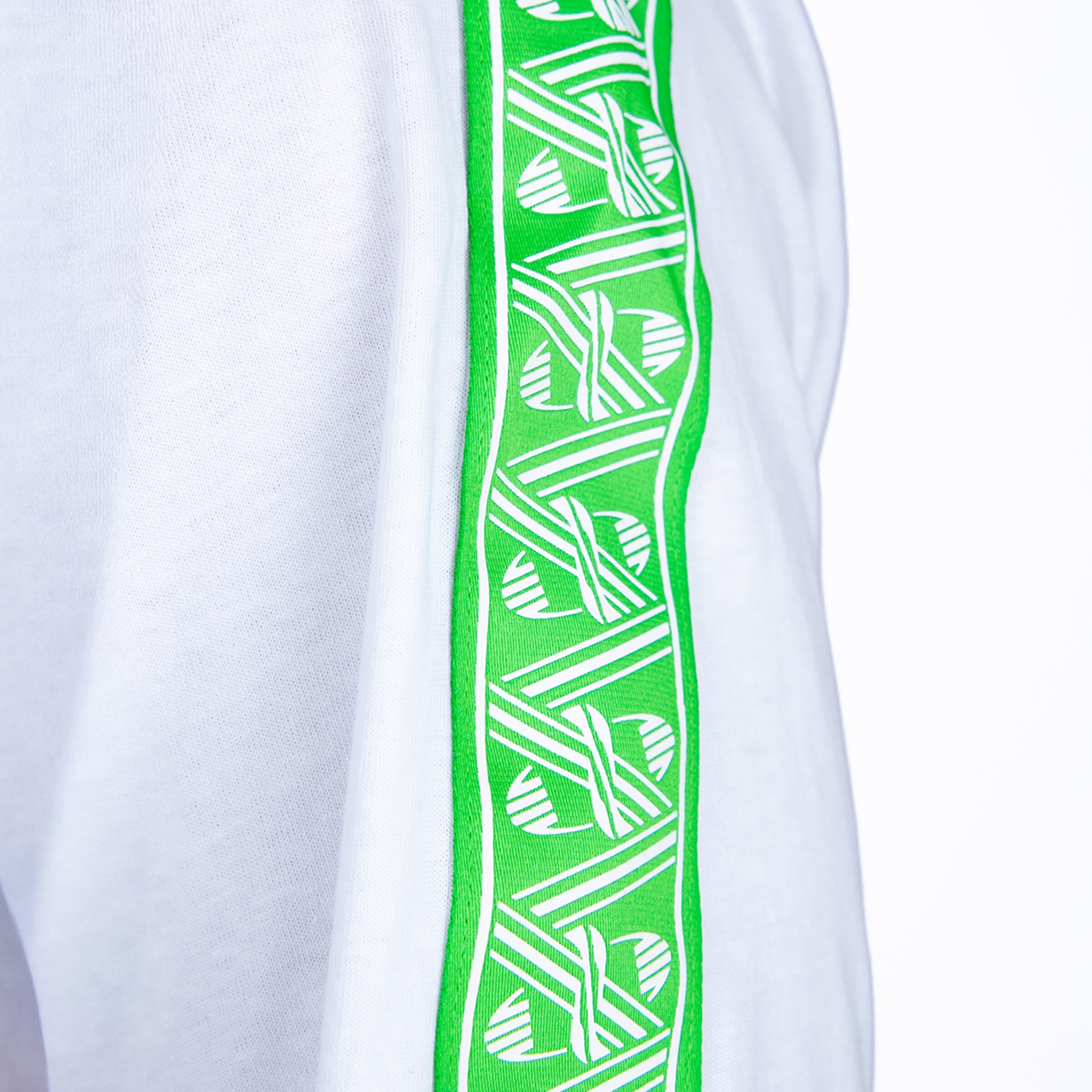 Close-up of white clothing with a green side stripe featuring a repeating white logo pattern.