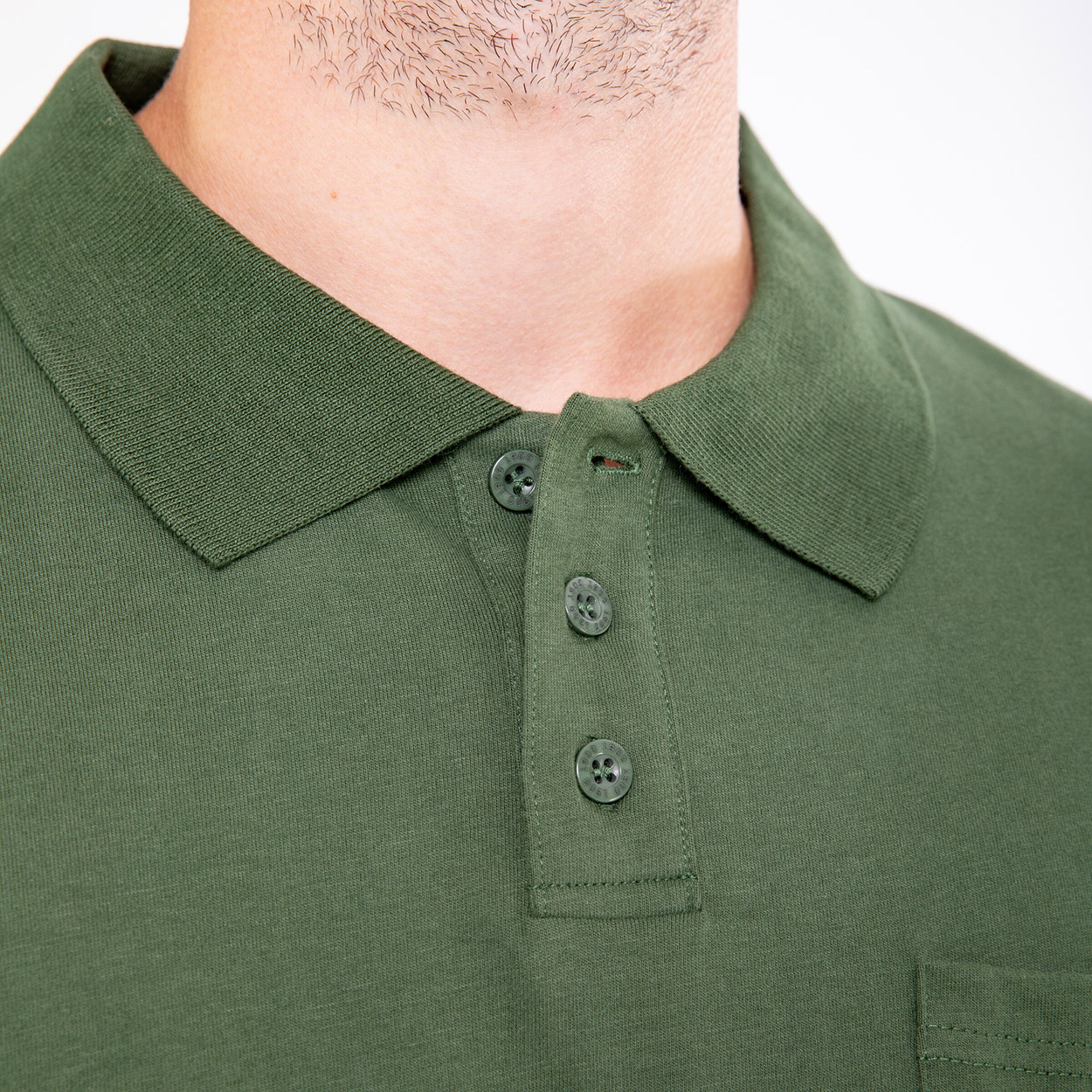 Olive green polo shirt featuring a short button placket and a chest pocket.