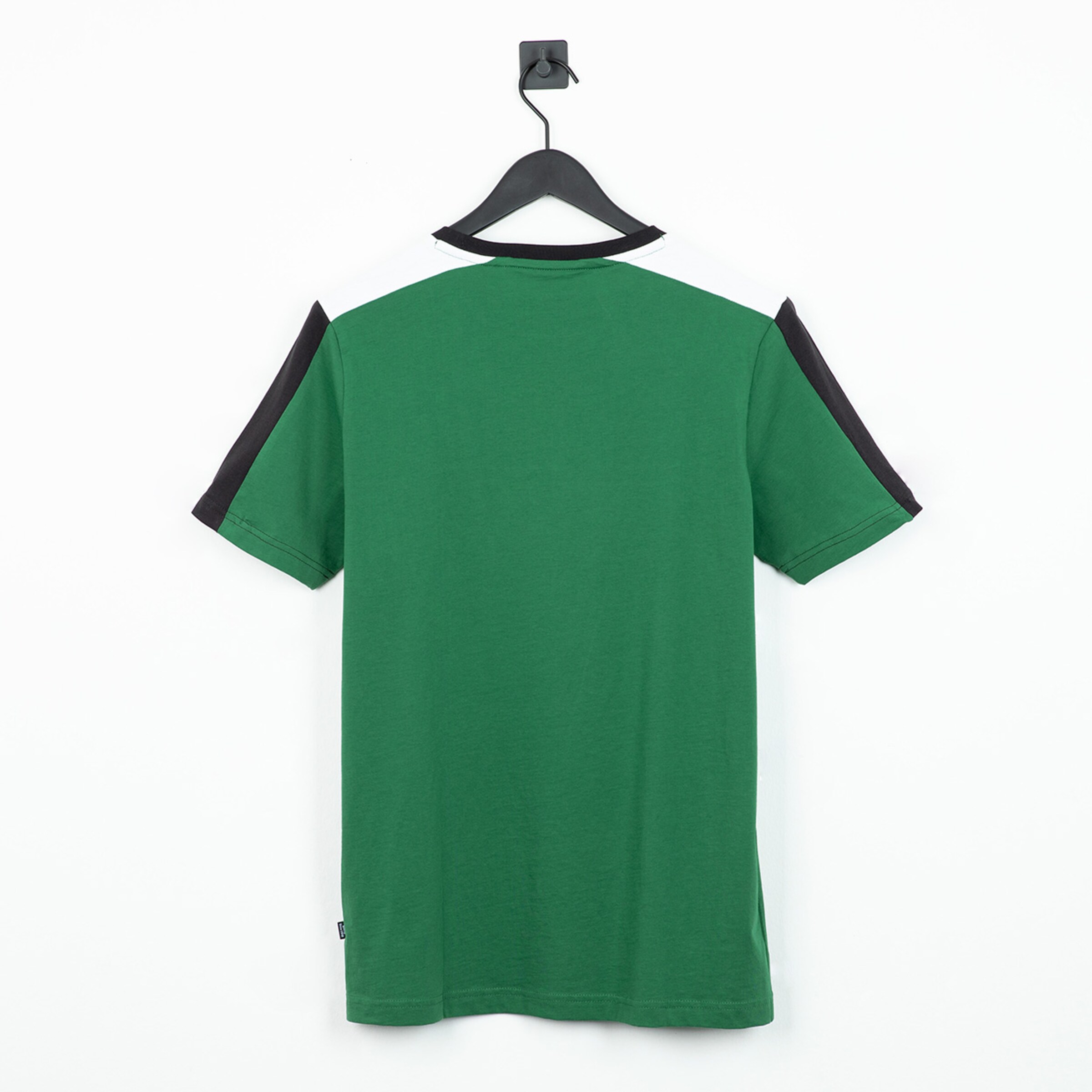 Back view of a green soccer jersey with black sleeves.