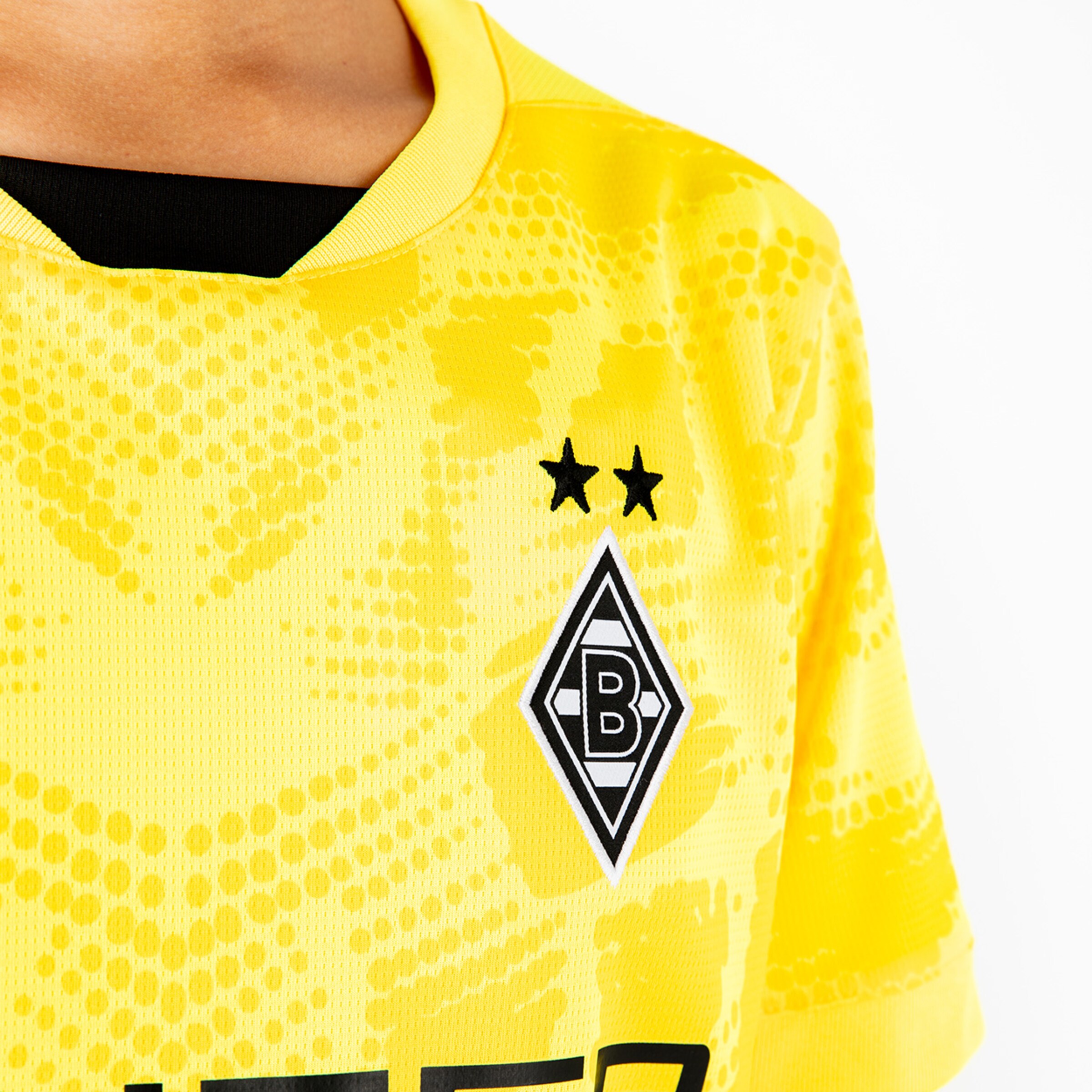 Torwarttrikot von Borussia Mönchengladbach in Gelb mit zwei Sternen und Vereinslogo.