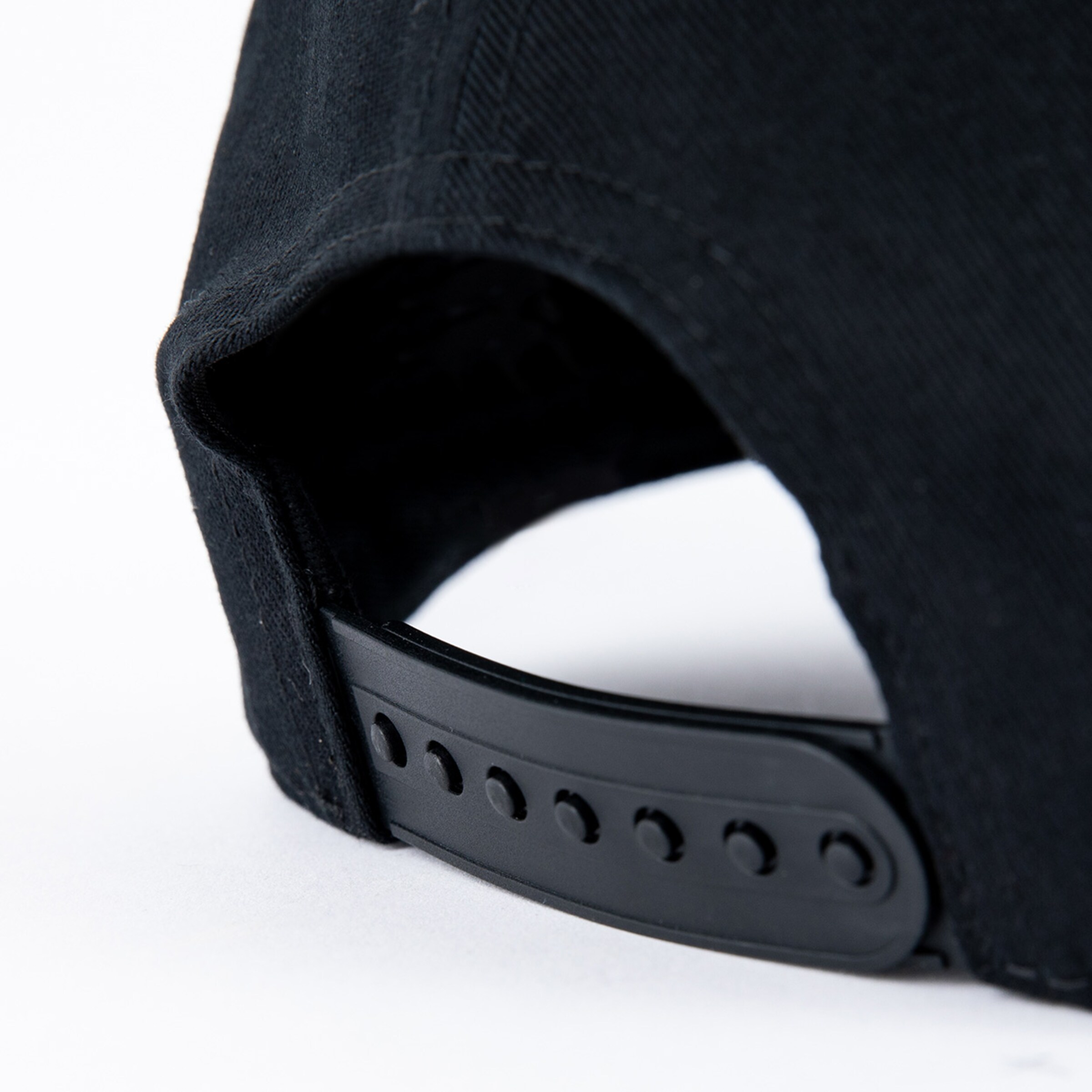 Black baseball cap with adjustable strap and curved brim.