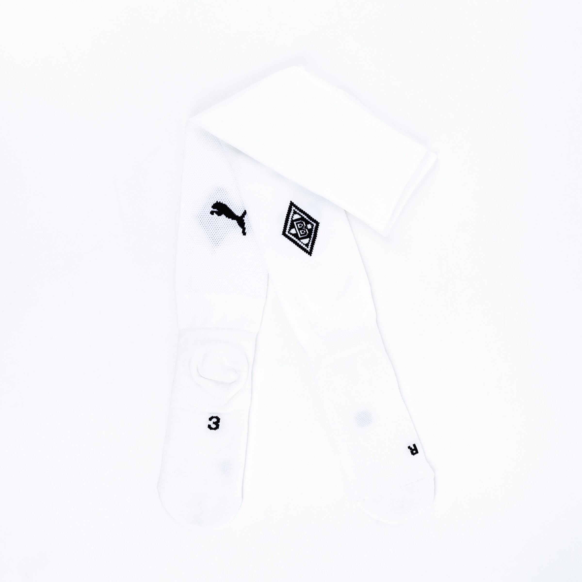 White soccer socks featuring a Puma logo and Borussia Mönchengladbach crest.