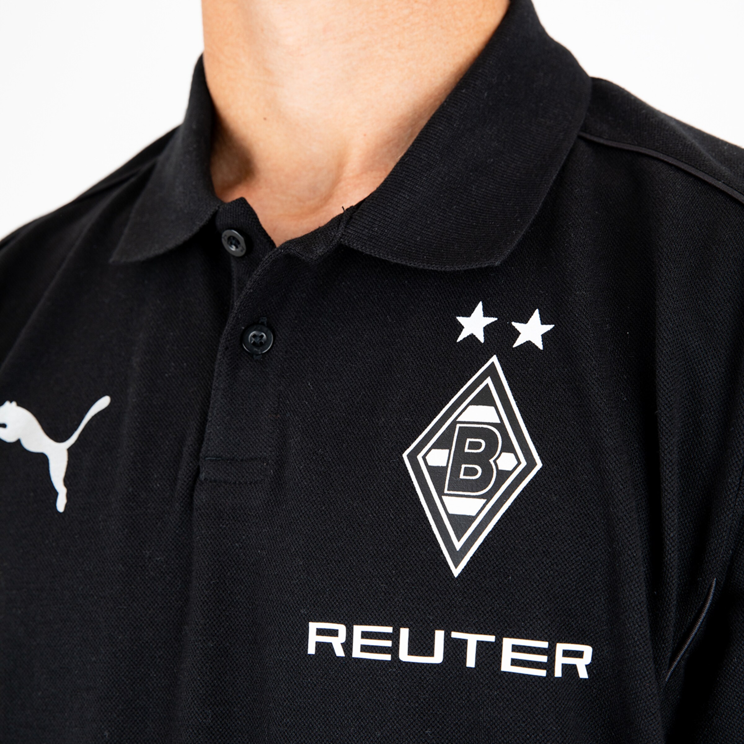 Schwarzes Polo-Shirt mit dem Borussia Mönchengladbach-Logo und der Aufschrift REUTER.